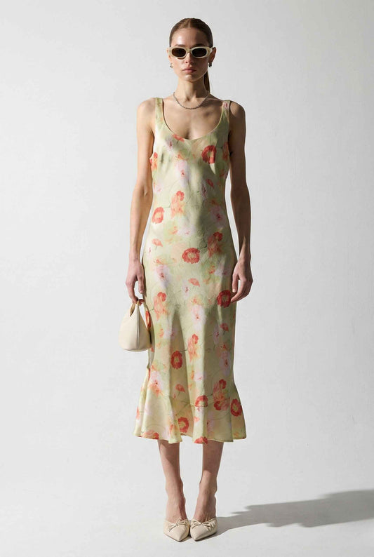 Woman wearing a Calliope Midi Light Green Floral Satin Slip Dress on a white background