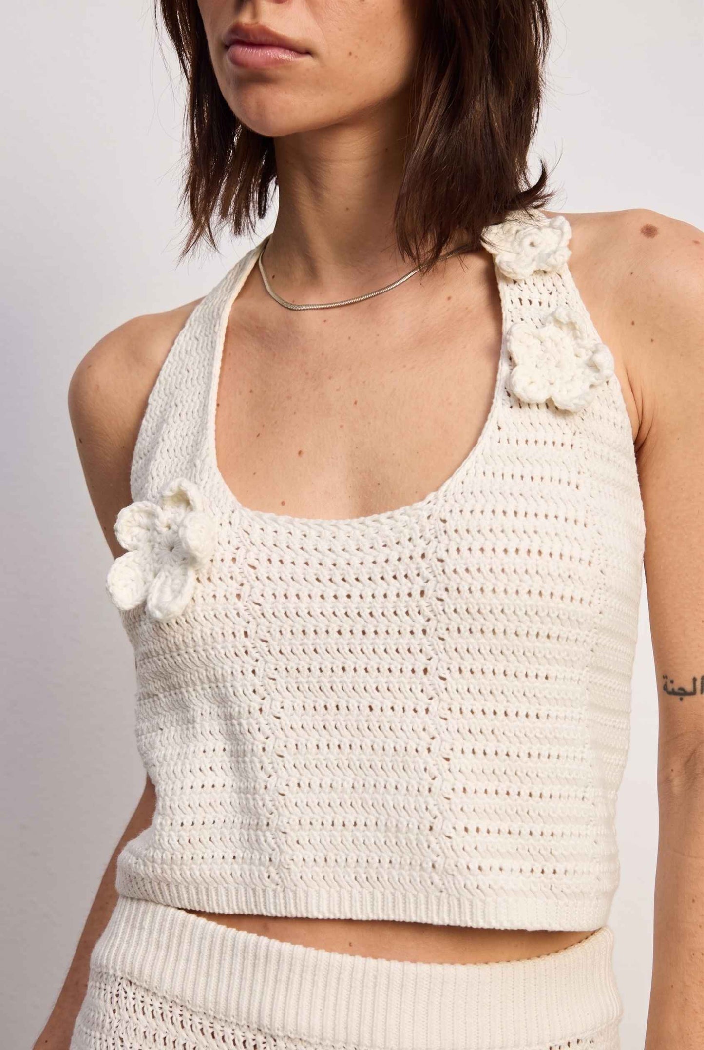 Model wearing Capri Floral Crochet Halter Top in Ivory Cotton Knit Crop Top with matching maxi skirt close up halter neckline