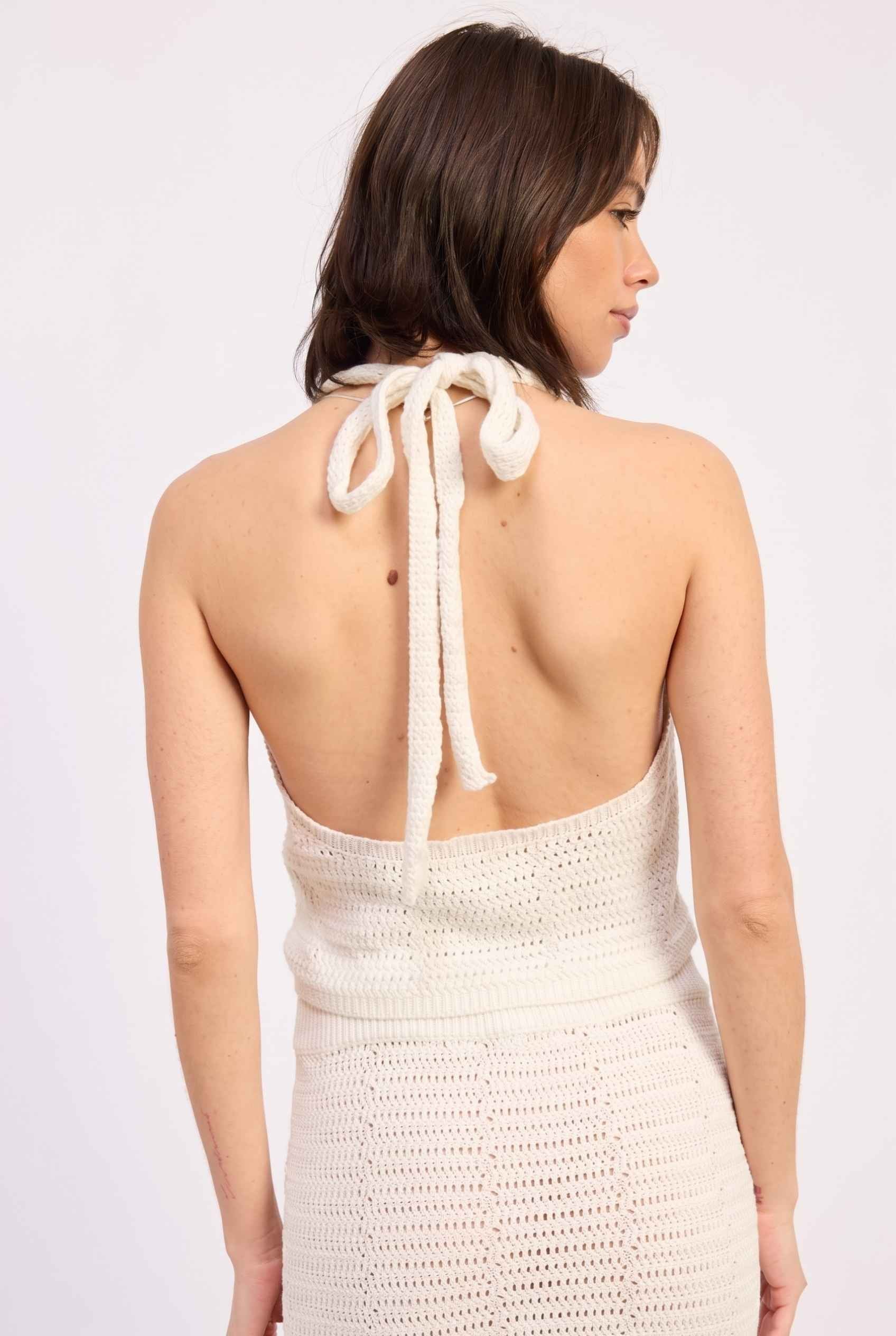 Model wearing Capri Floral Crochet Halter Top in Ivory Cotton Knit Crop Top with matching maxi skirt back view tie-up neck