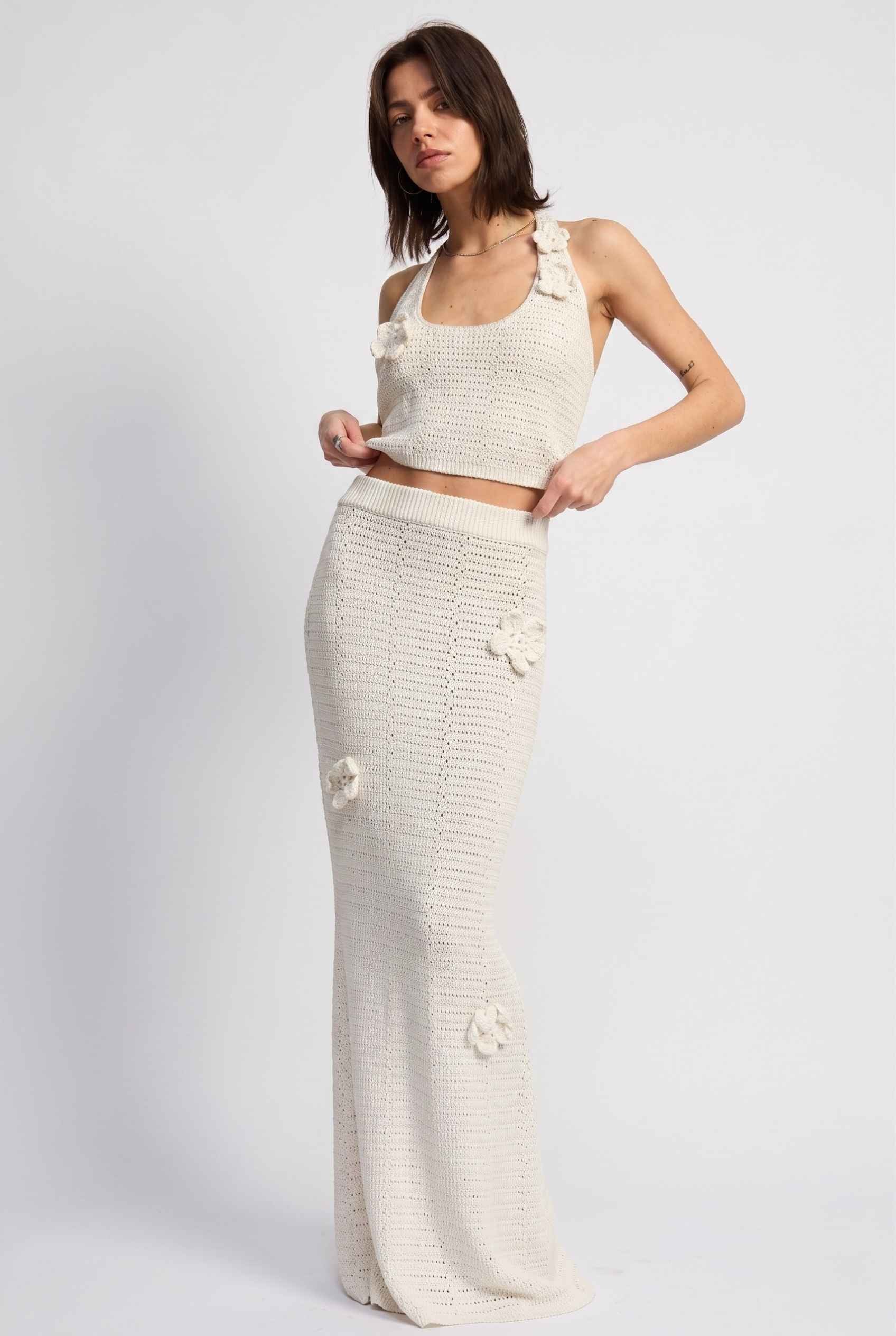 Model wearing Capri Floral Crochet Maxi Skirt in Ivory Cotton Knit Long Skirt paired with matching tank top posing