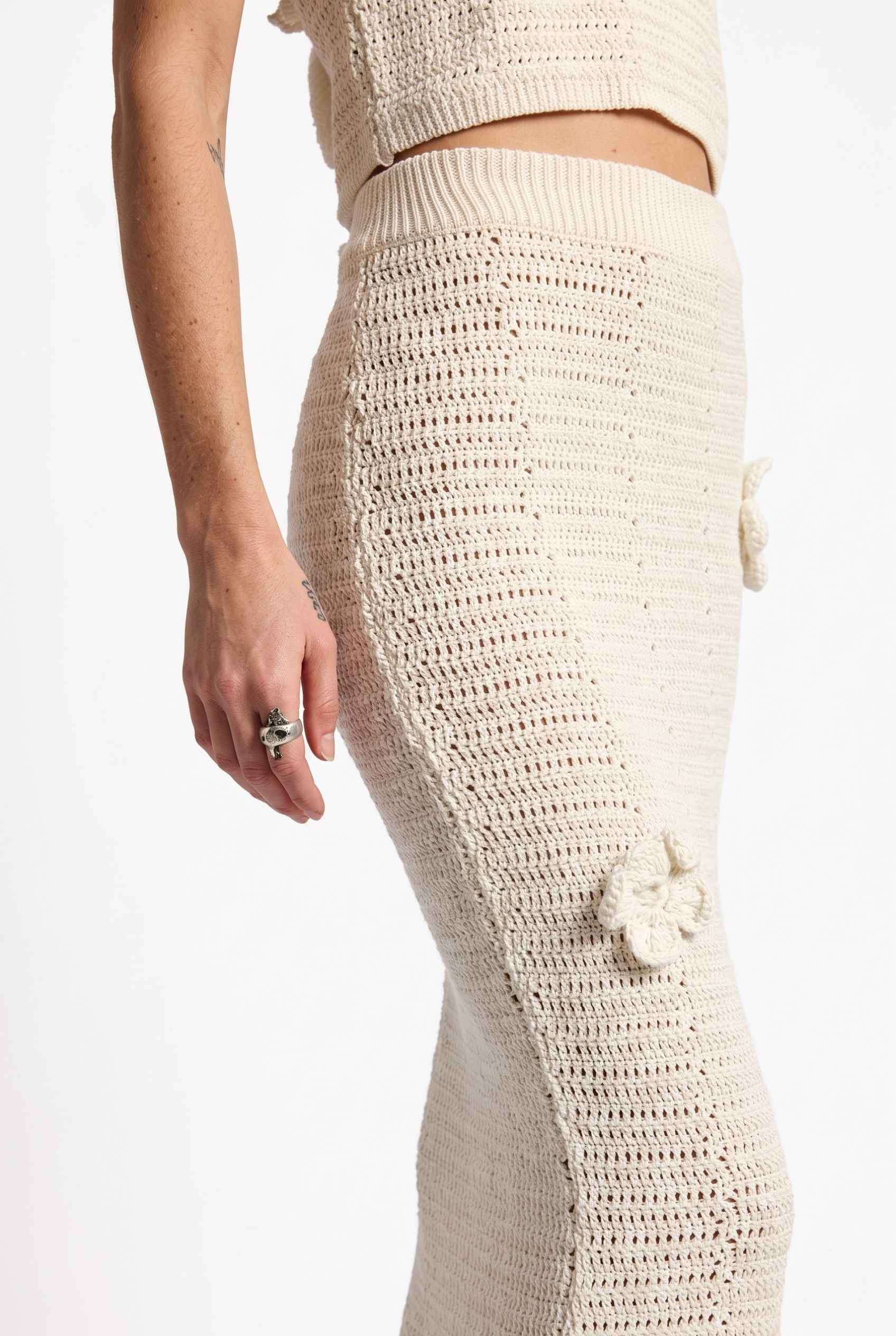 Model wearing Capri Floral Crochet Maxi Skirt in Ivory Cotton Knit Long Skirt paired with matching tank top close up applique detail