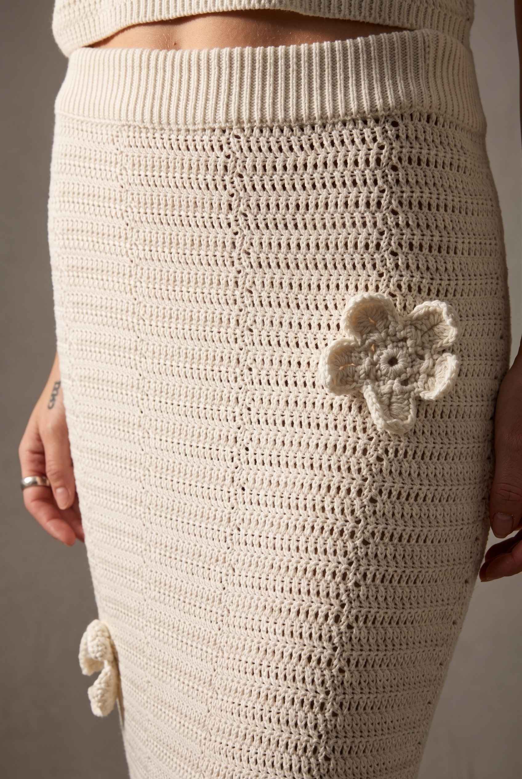 Model wearing Capri Floral Crochet Maxi Skirt in Ivory Cotton Knit Long Skirt paired with matching tank top close up intricate delicate stitching