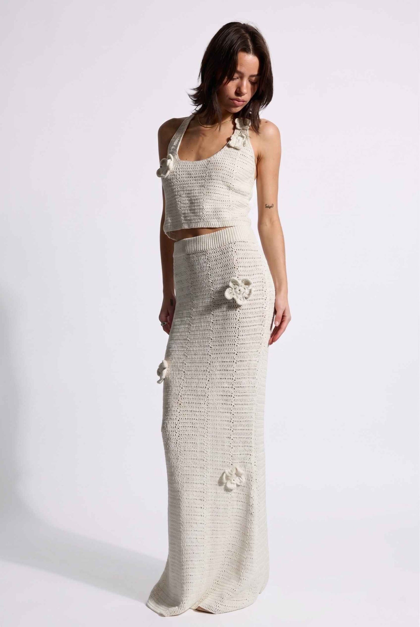 Model wearing Capri Floral Crochet Maxi Skirt in Ivory Cotton Knit Long Skirt paired with matching tank top posing