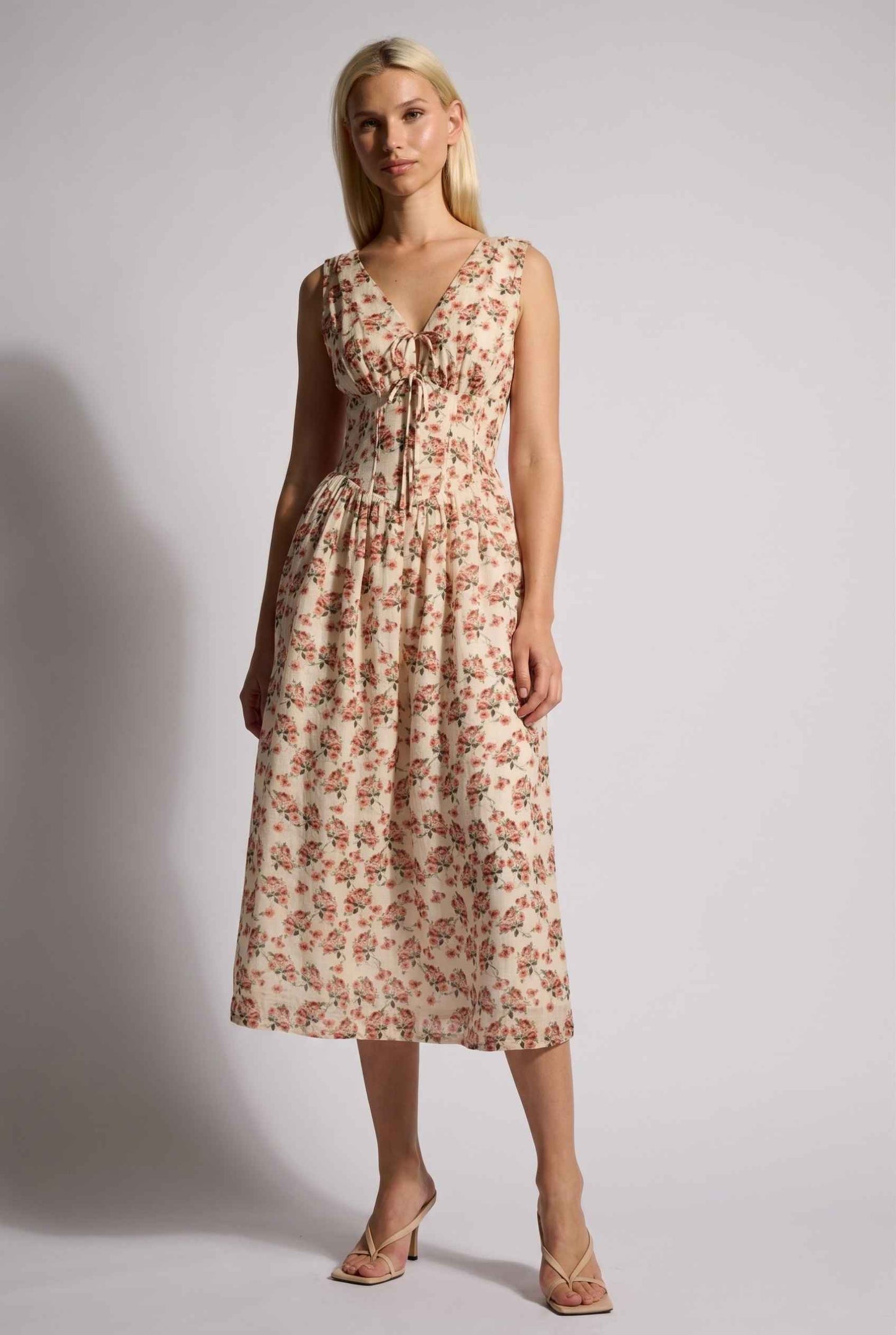 Model wearing Carolina Floral V-Neck Fit and Flare Dress Corset Midi Dress in Ivory paired with kitten heels