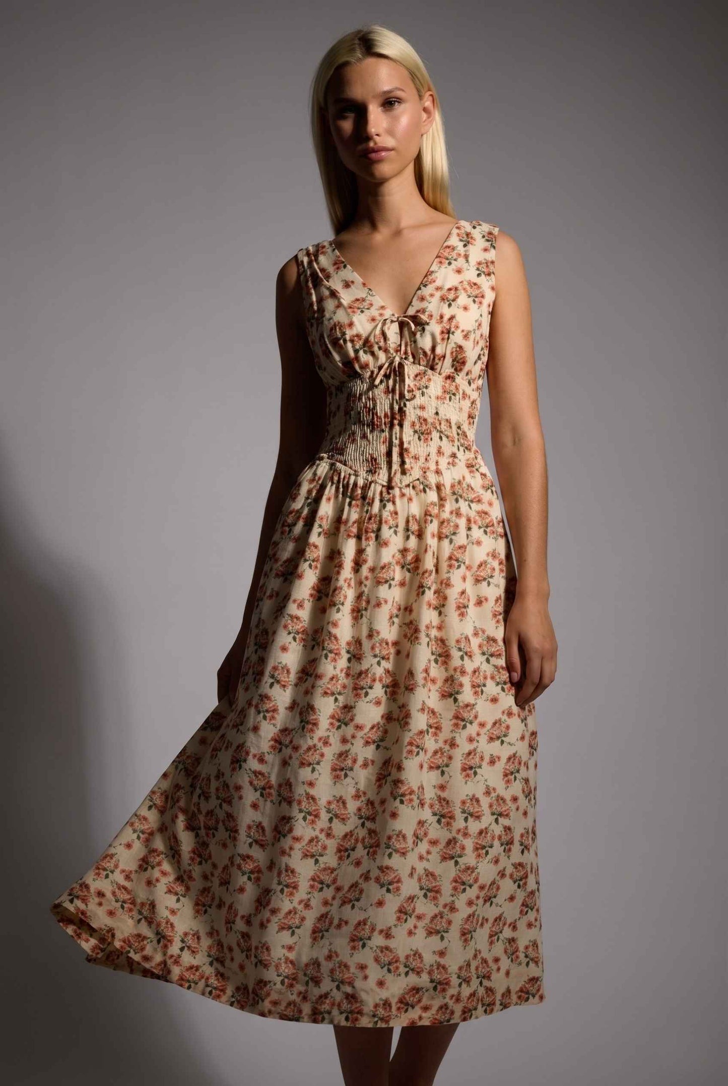 Model wearing Carolina Floral V-Neck Fit and Flare Dress Corset Midi Dress in Ivory vintage floral pattern