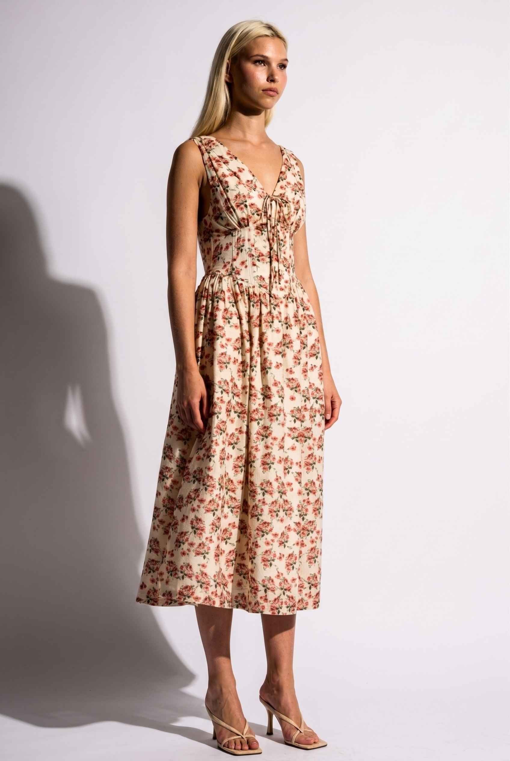 Model wearing Carolina Floral V-Neck Fit and Flare Dress Corset Midi Dress in Ivory paired with kitten heels