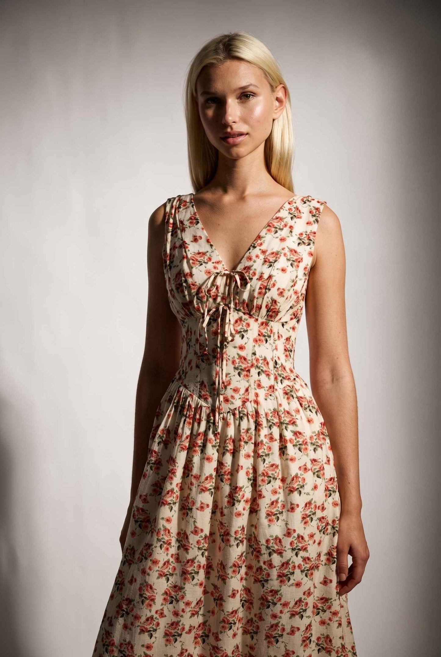 Model wearing Carolina Floral V-Neck Fit and Flare Dress Corset Midi Dress close up front tied detail