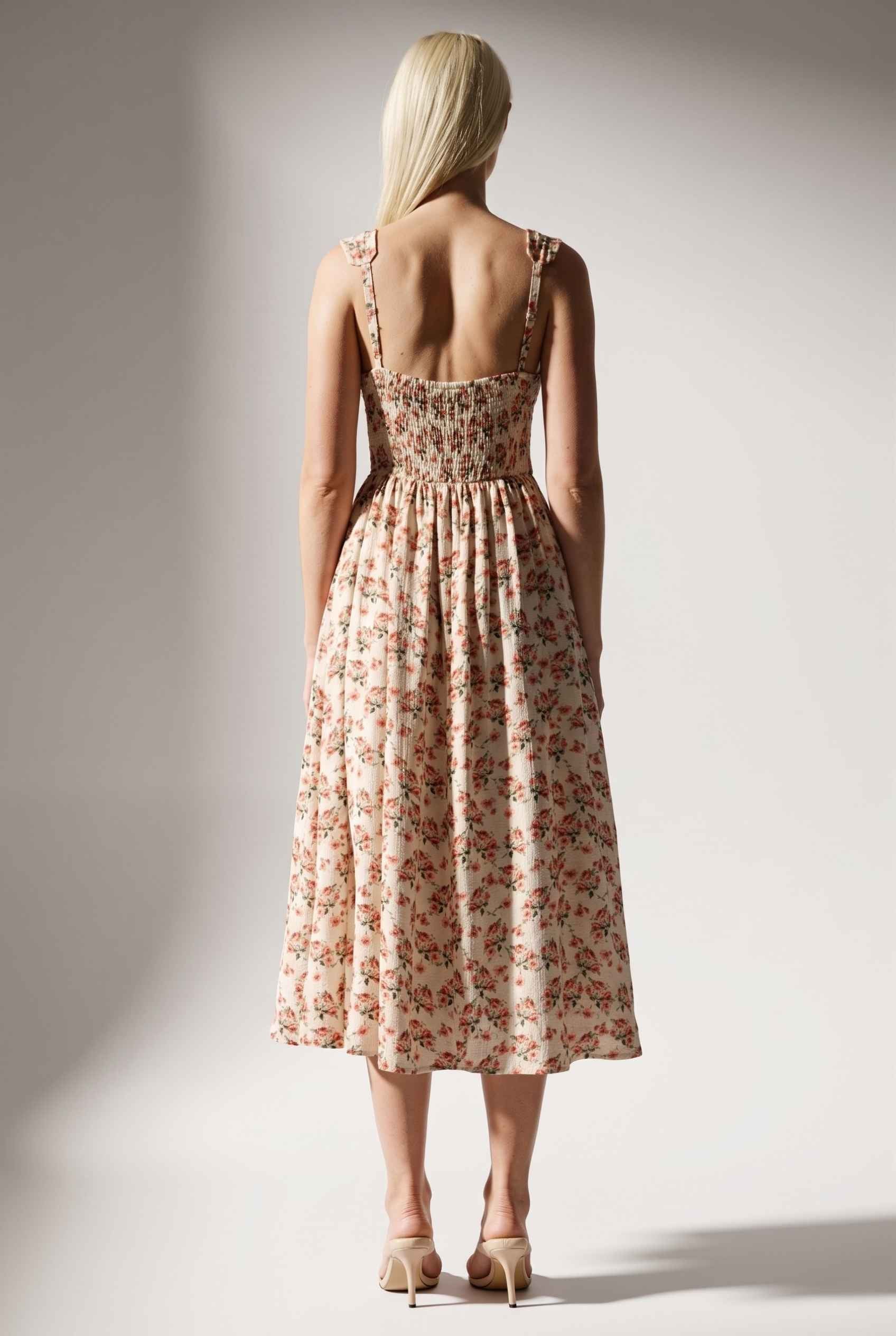 Model wearing Carolina Floral V-Neck Fit and Flare Dress Corset Midi Dress in Ivory paired with kitten heels back view