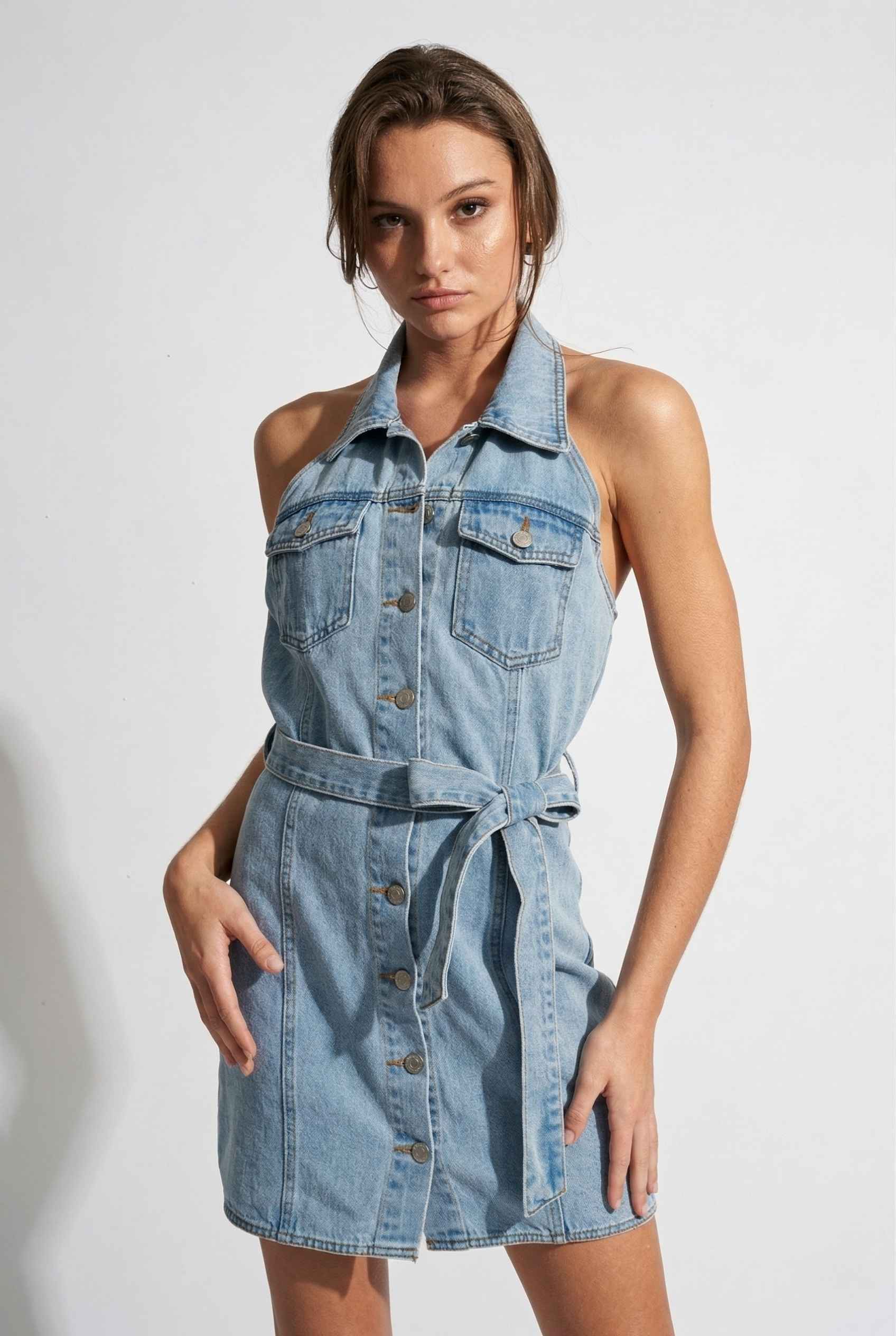 Model wearing Cassidy Mini in Light Wash Denim Button-Front Dress