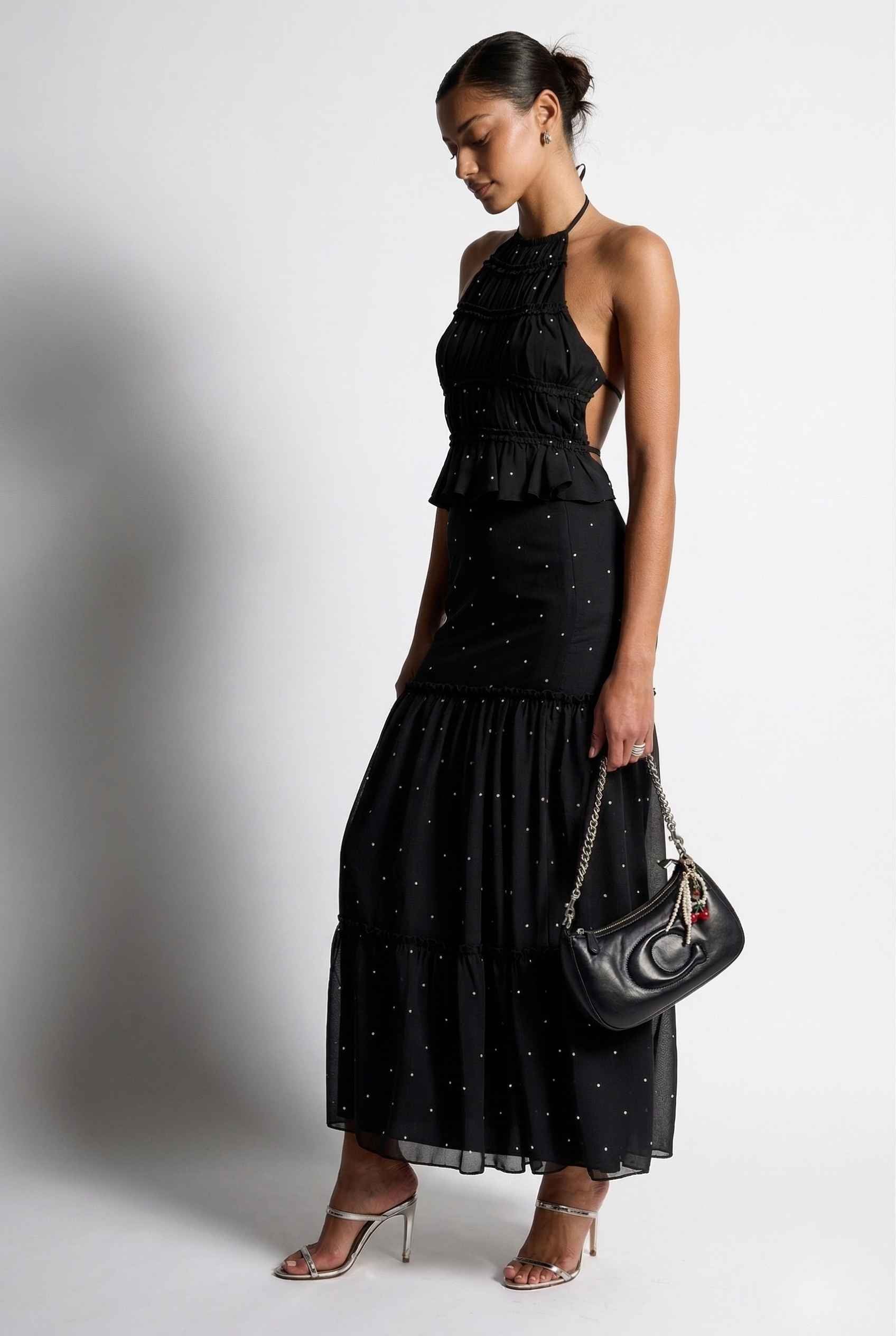 Clara Skirt Black Tiered Ruffle Polka Dot Midi Skirt with a plain background
