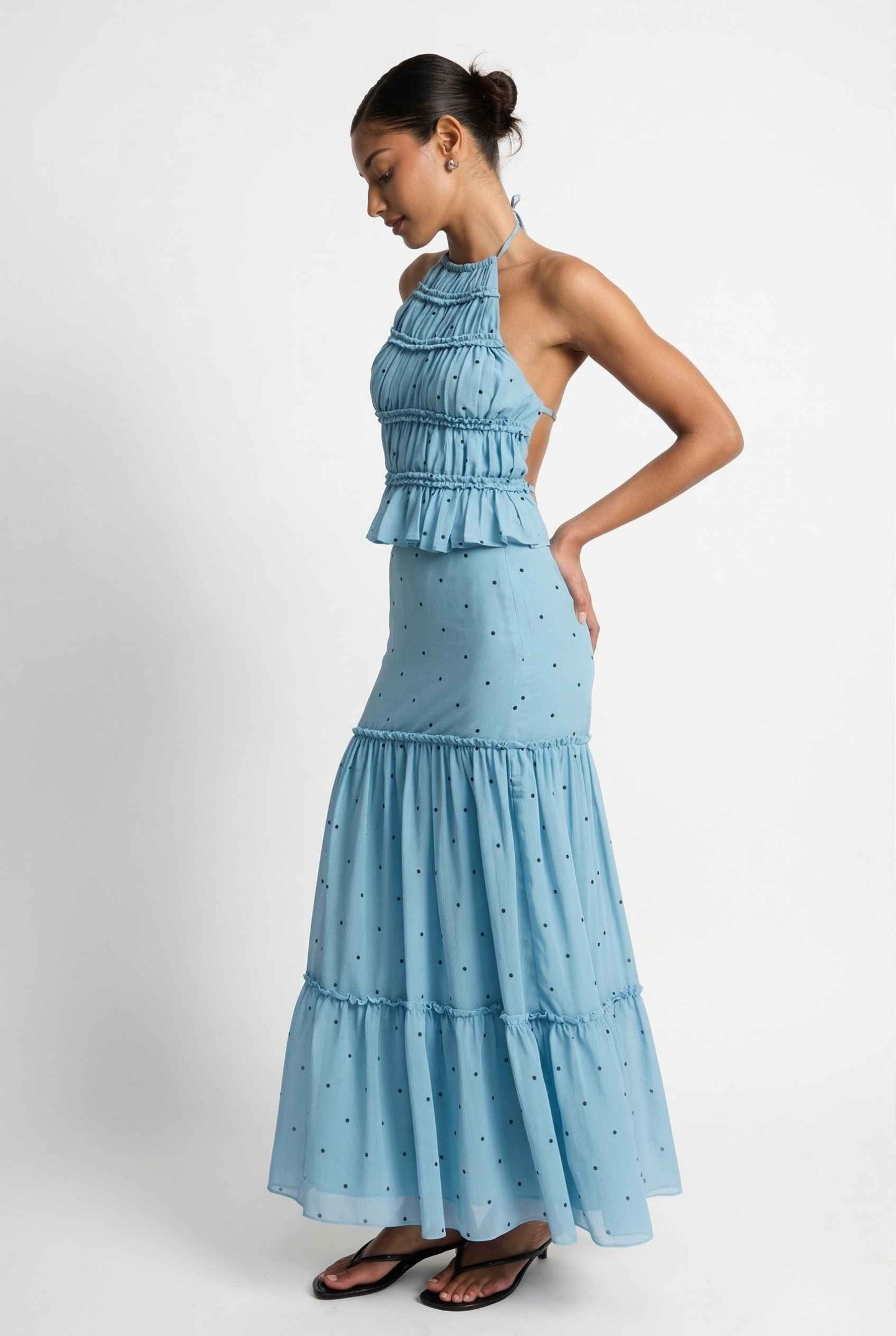 Woman wearing a Clara Skirt Blue Tiered Ruffle Polka Dot Midi Skirt against a plain background