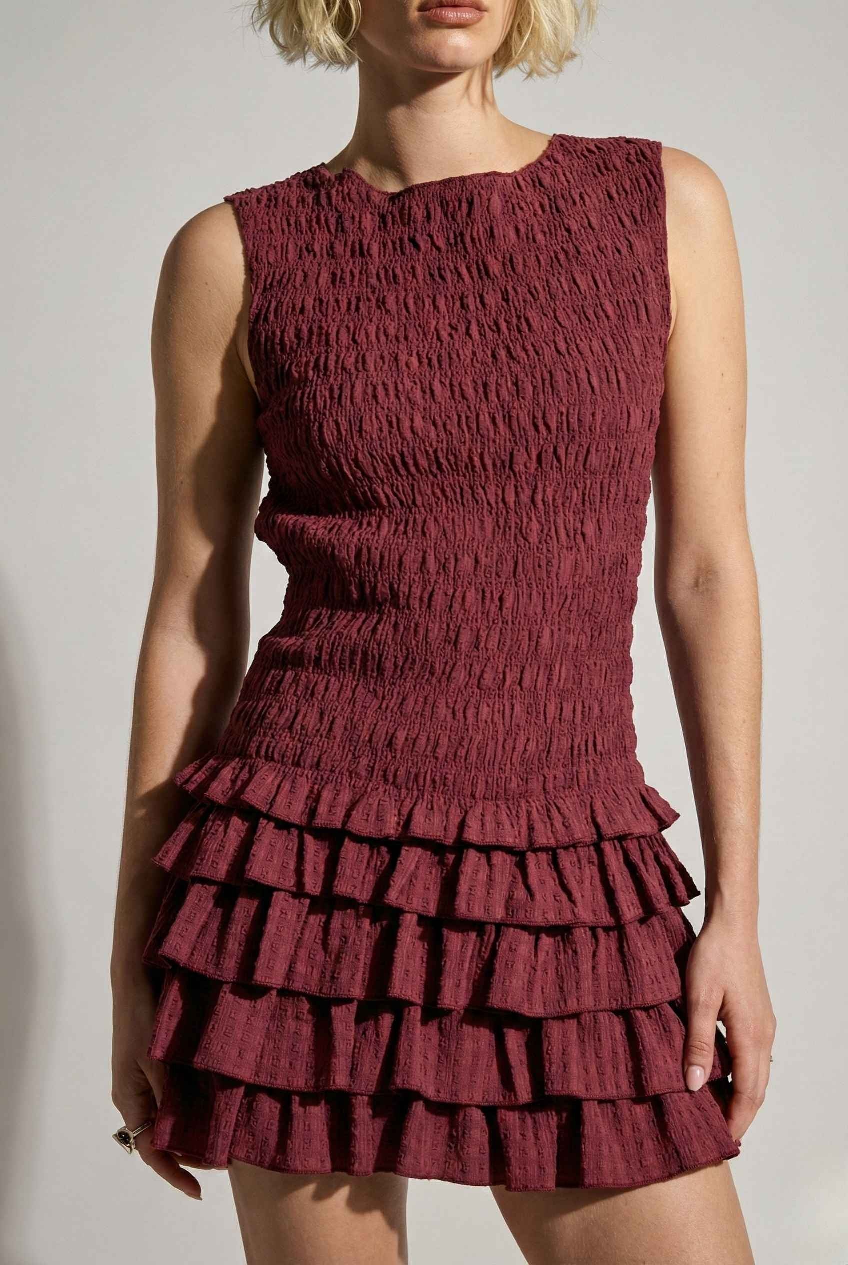 Cleo Mini Wine Smocked Ruffle Sleeveless Dress worn by a model against a plain background