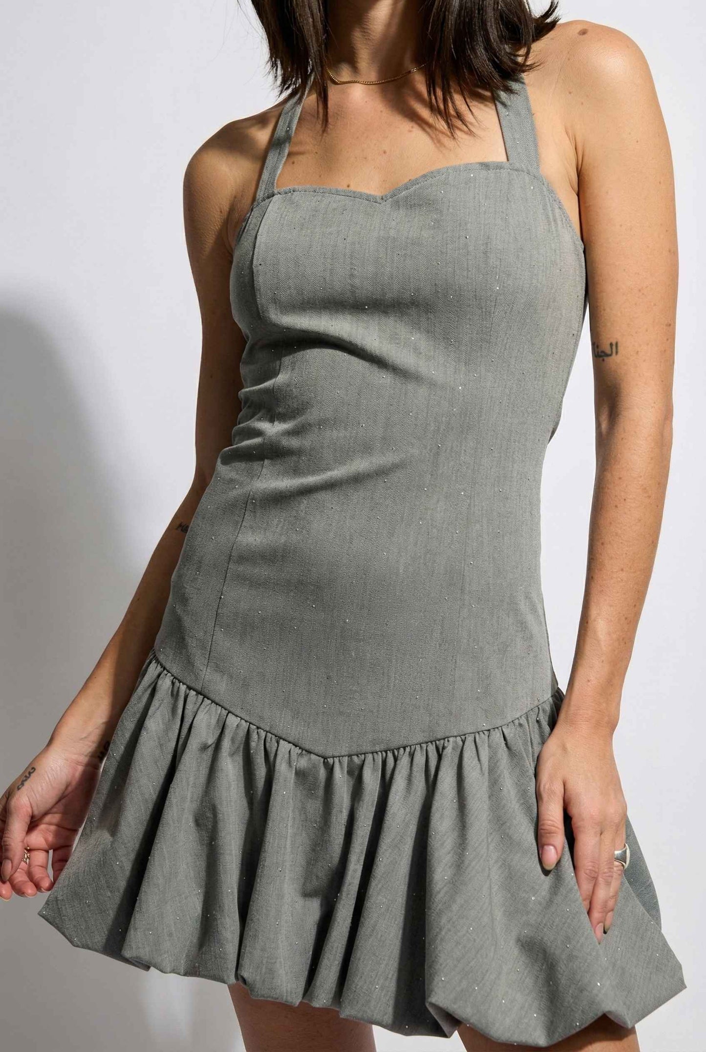 Colette Mini Grey Rhinestone Drop-Waist Bubble Dress worn by a woman on a white background