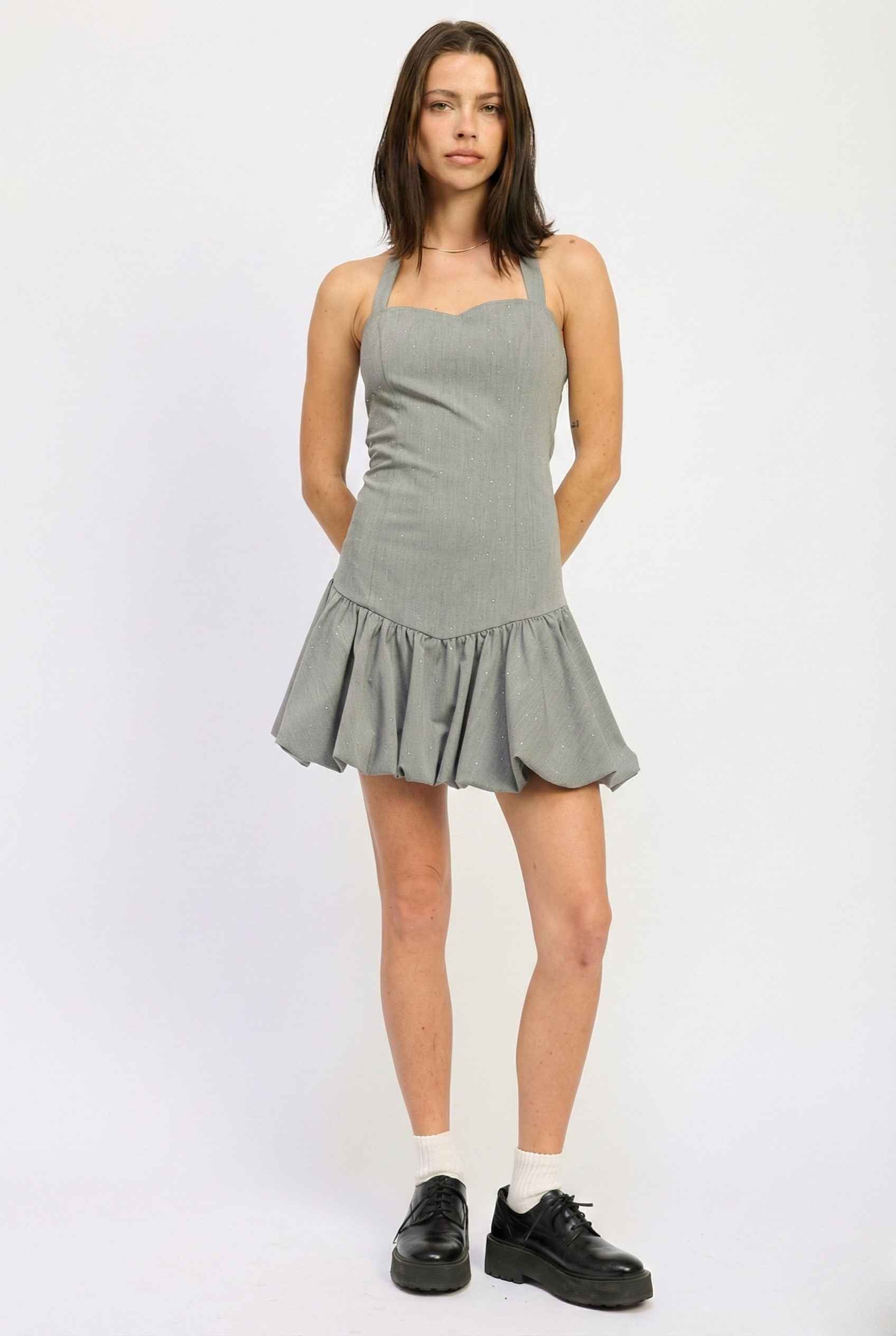 Woman wearing a Colette Mini Grey Rhinestone Drop-Waist Bubble Dress on a white background