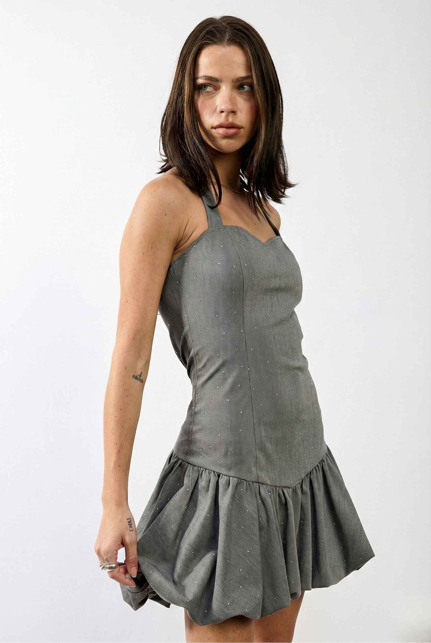 Woman wearing a Colette Mini Grey Rhinestone Drop-Waist Bubble Dress against a white background