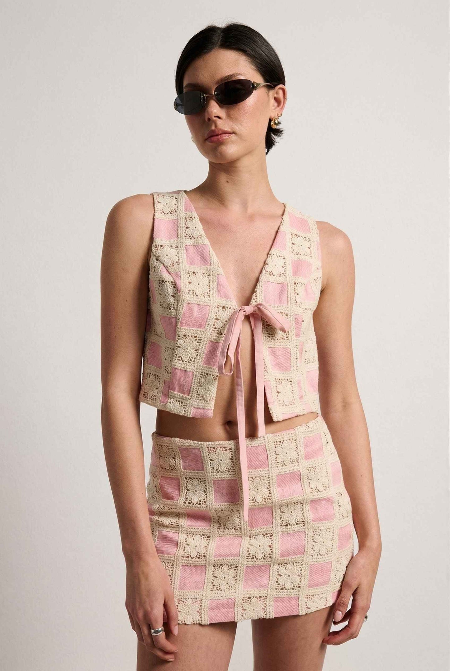 Model wearing Daphne Skirt in Pink Modern Jacquard Checkerboard Mini Skirt with matching vest top 