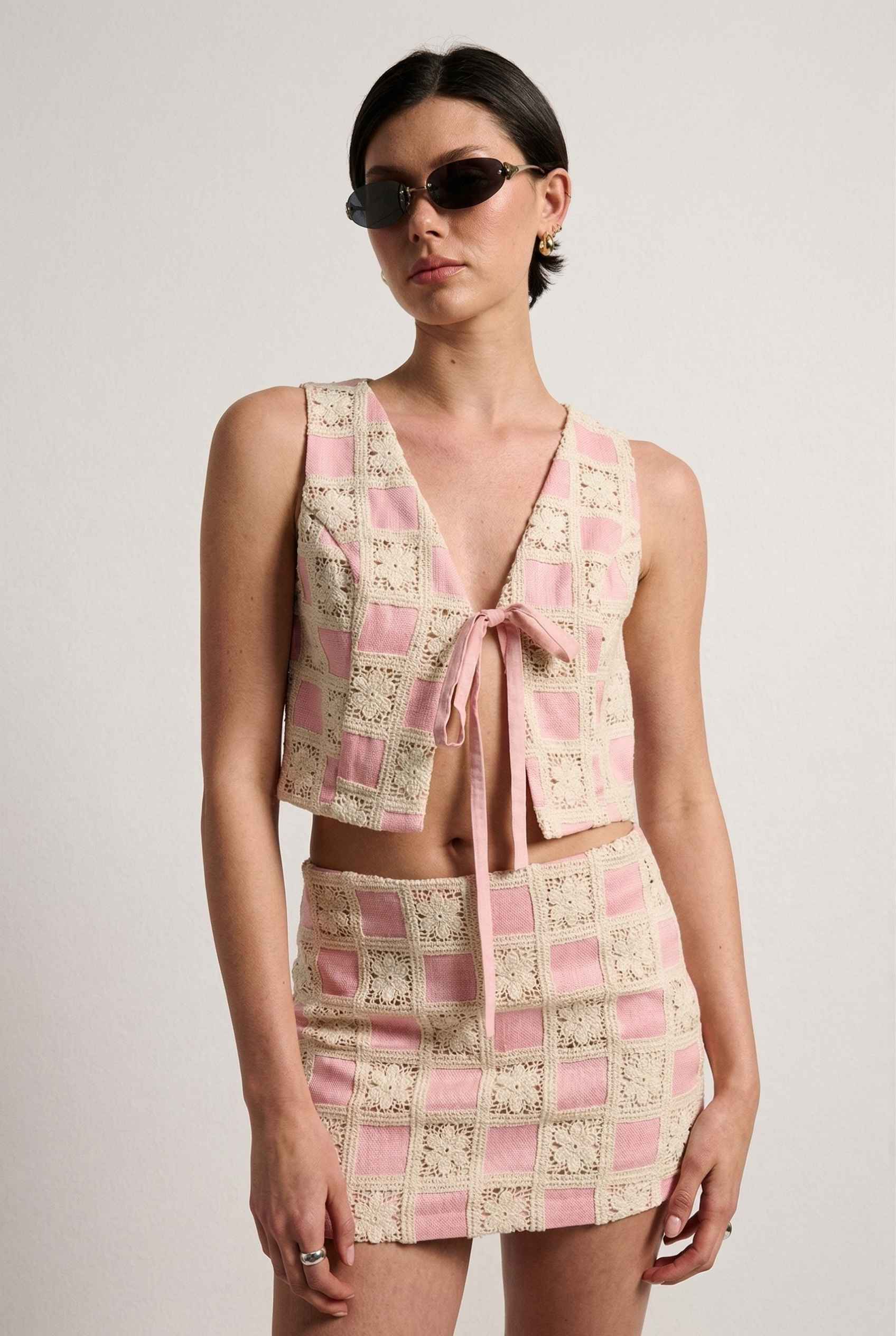 Model wearing Daphne Skirt in Pink Modern Jacquard Checkerboard Mini Skirt with matching vest top 