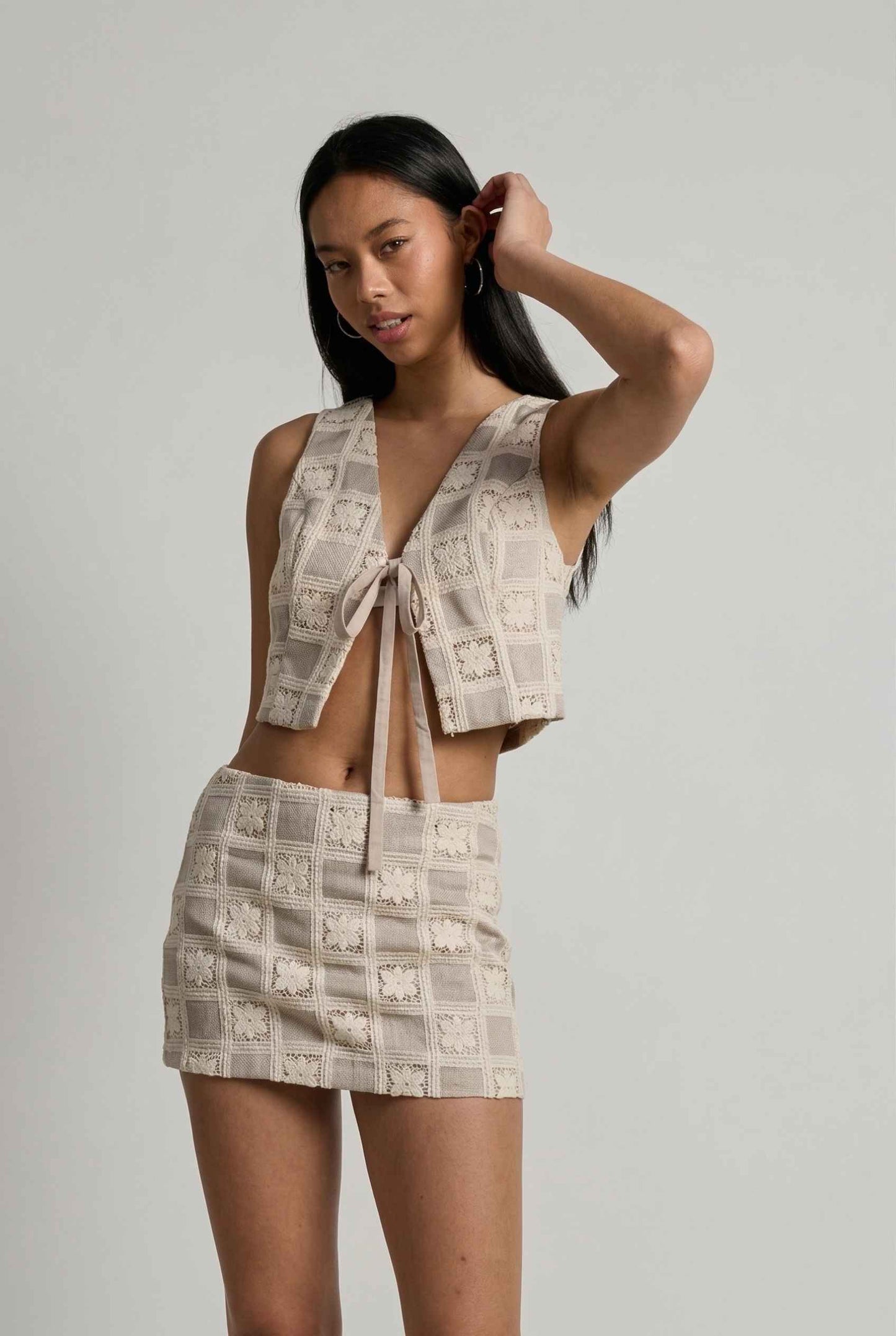 Model wearing Daphne Skirt in Natural Modern Jacquard Checkerboard Mini Skirt with matching vest top 