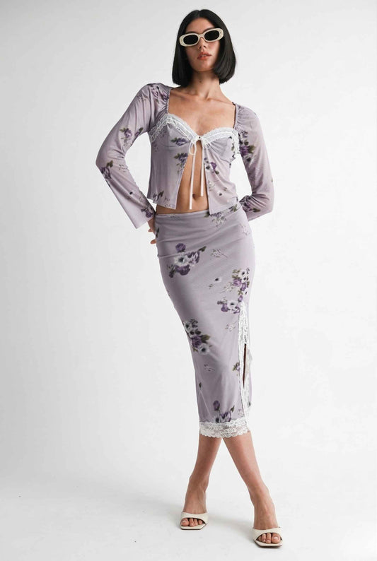 Woman wearing a Elara Skirt Lilac Floral Mesh Midi Skirt with Lace Slit with a white background
