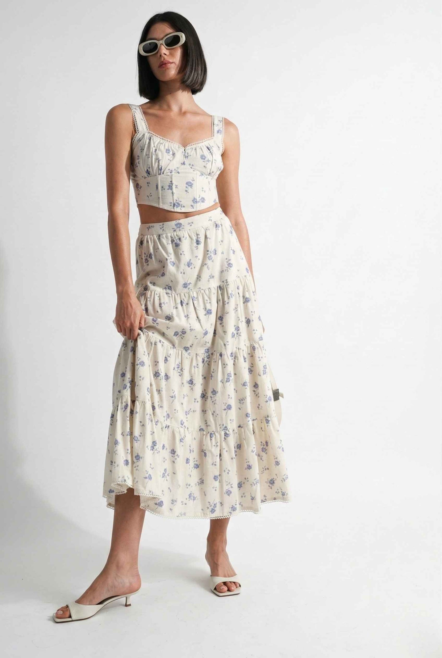 Woman wearing a Eliana Top White & Blue Floral Cotton Corset Crop on a white background