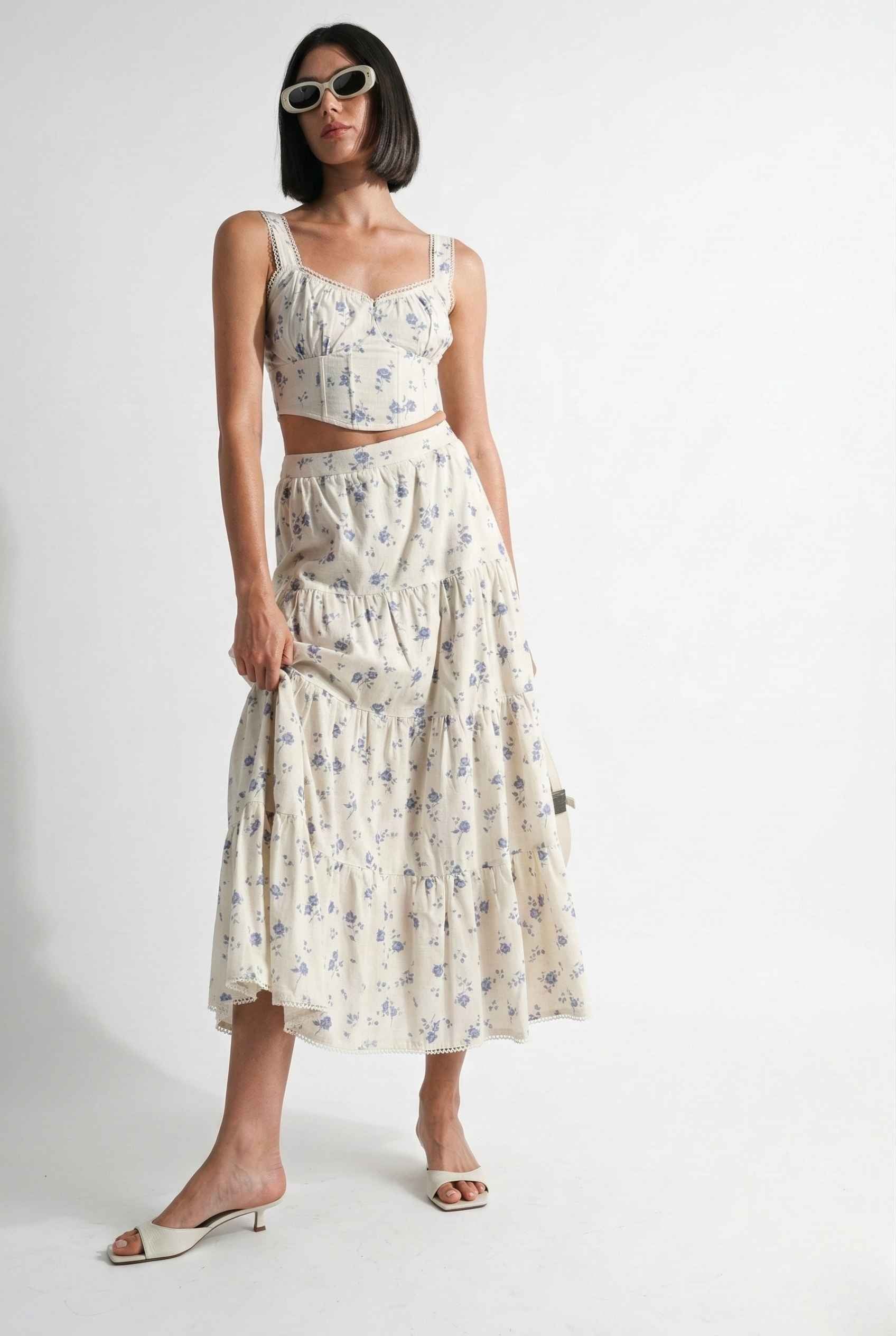 Woman wearing a Eliana Top White & Blue Floral Cotton Corset Crop on a white background