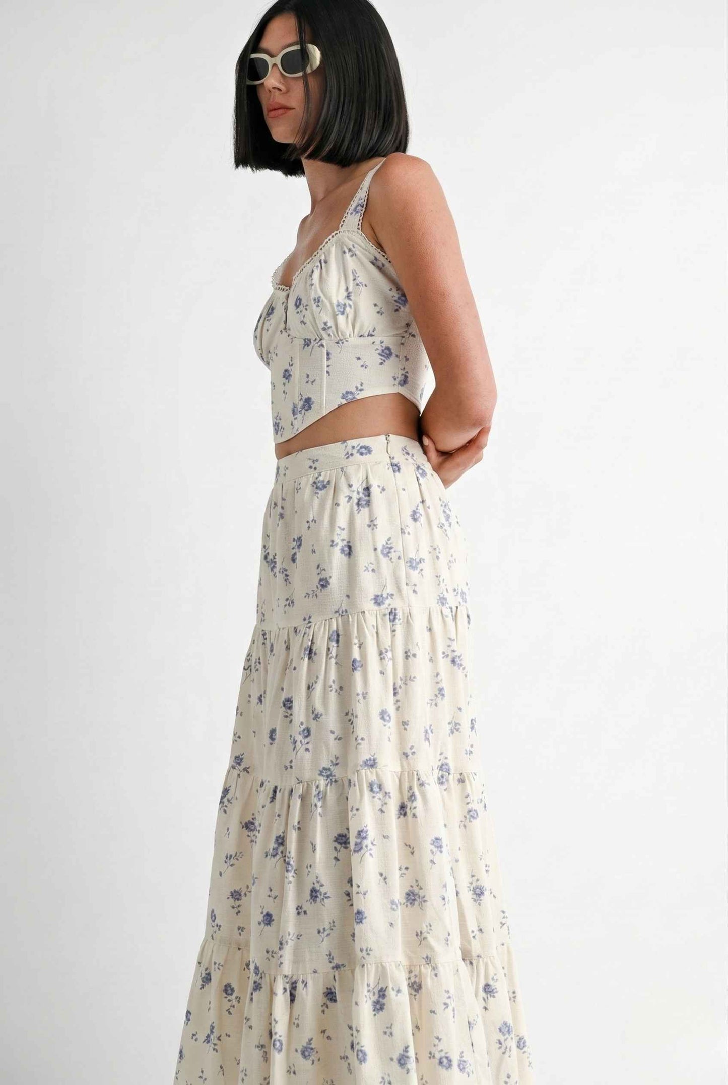 Woman wearing a Eliana Top White & Blue Floral Cotton Corset Crop on a white background