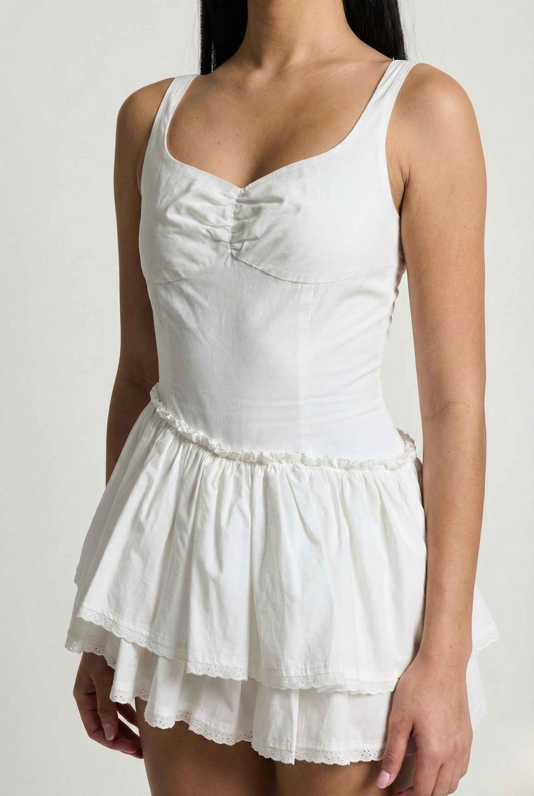 Elodie Mini White Tiered Ruffle Cotton Mini Dress on a plain background