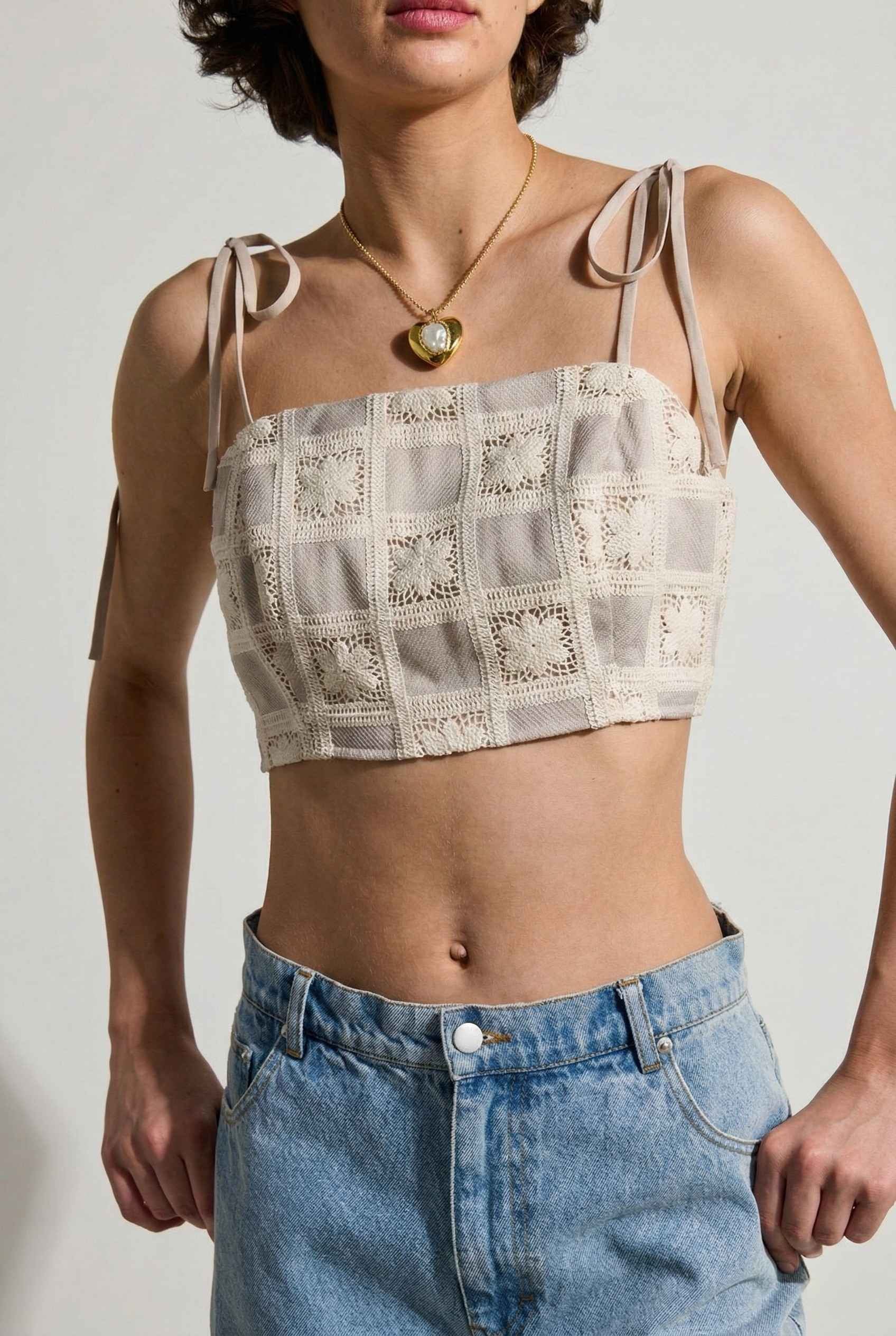 Model wearing Elodie Top in Natural Jacquard Square Neck Cami with Ribbon Tie Straps with denim shorts on a plain background