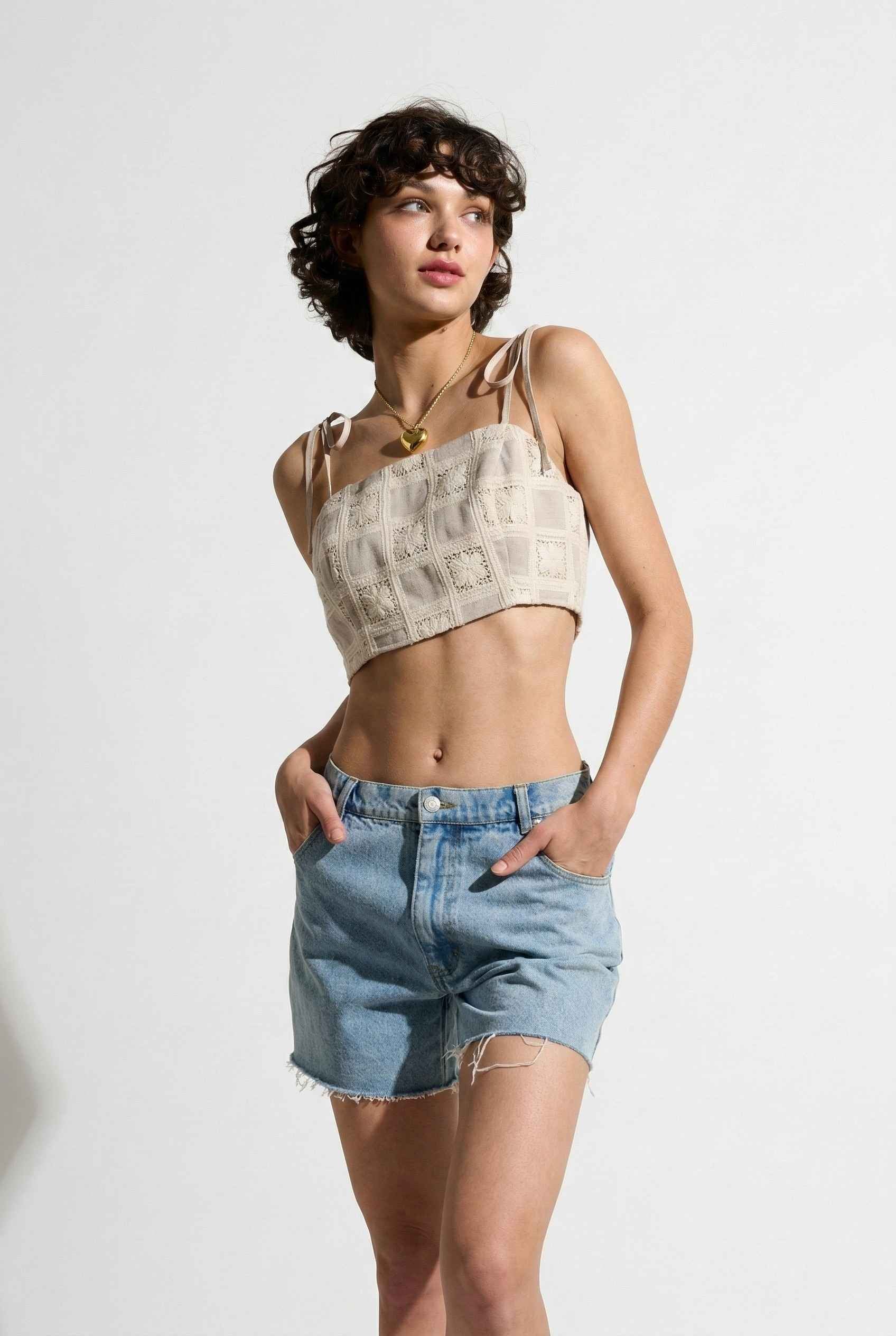 Model wearing Elodie Top in Natural Jacquard Square Neck Cami with Ribbon Tie Straps with denim shorts on a plain background