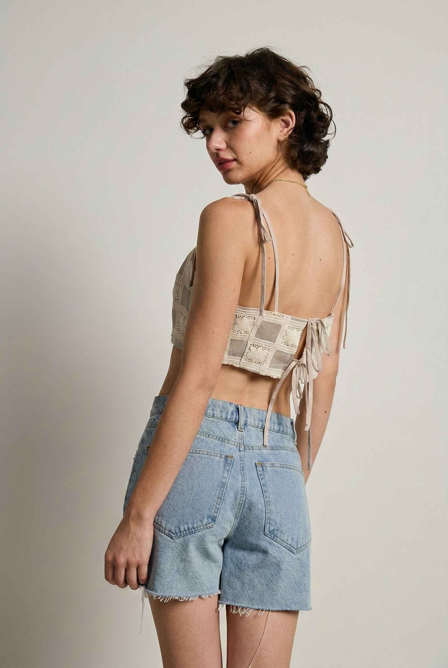 Model wearing Elodie Top in Natural Jacquard Square Neck Cami with Ribbon Tie Straps with denim shorts on a plain background