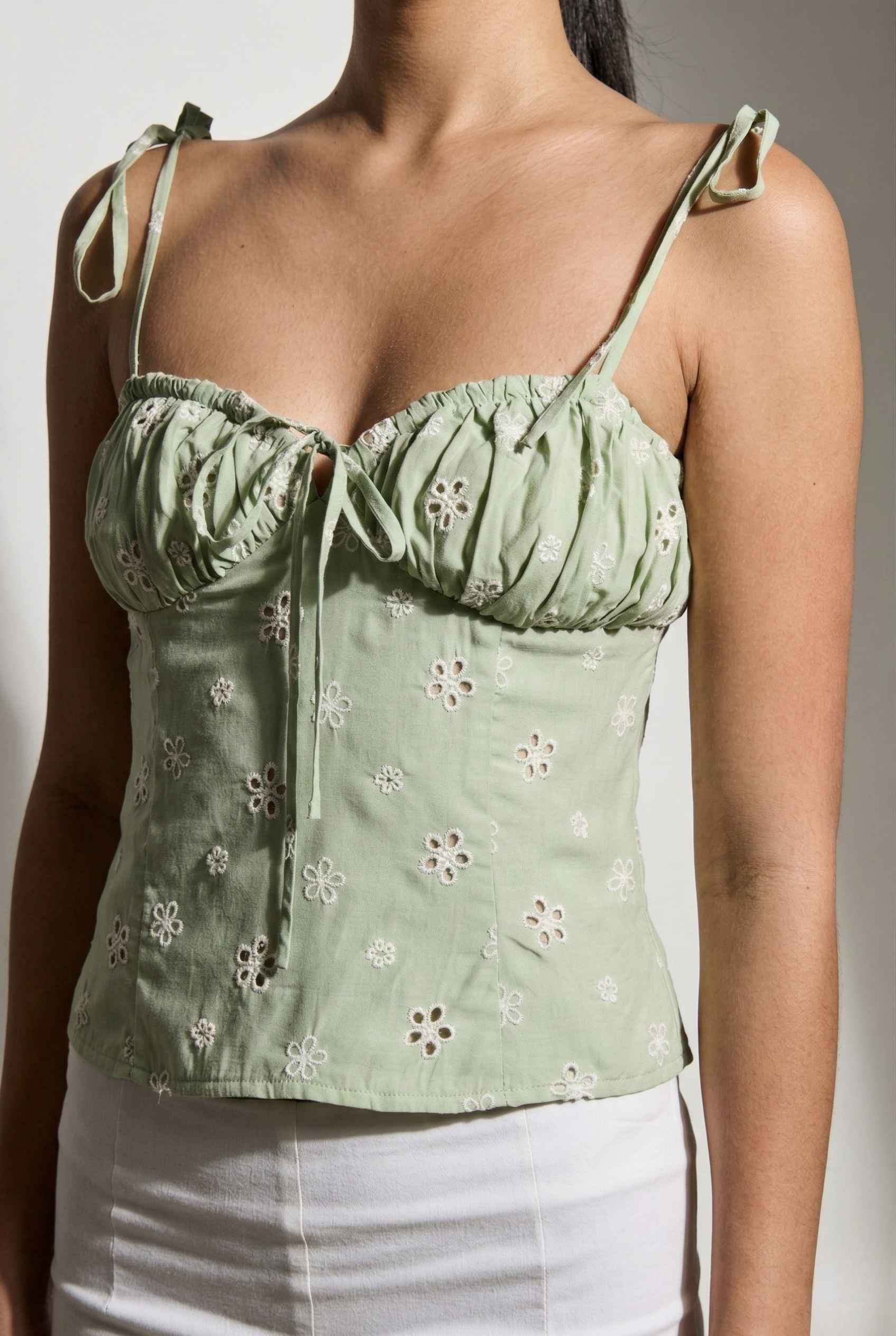Elodie Top Mint Floral Embroidered Tie-Strap Corset Top worn by a person on a plain background