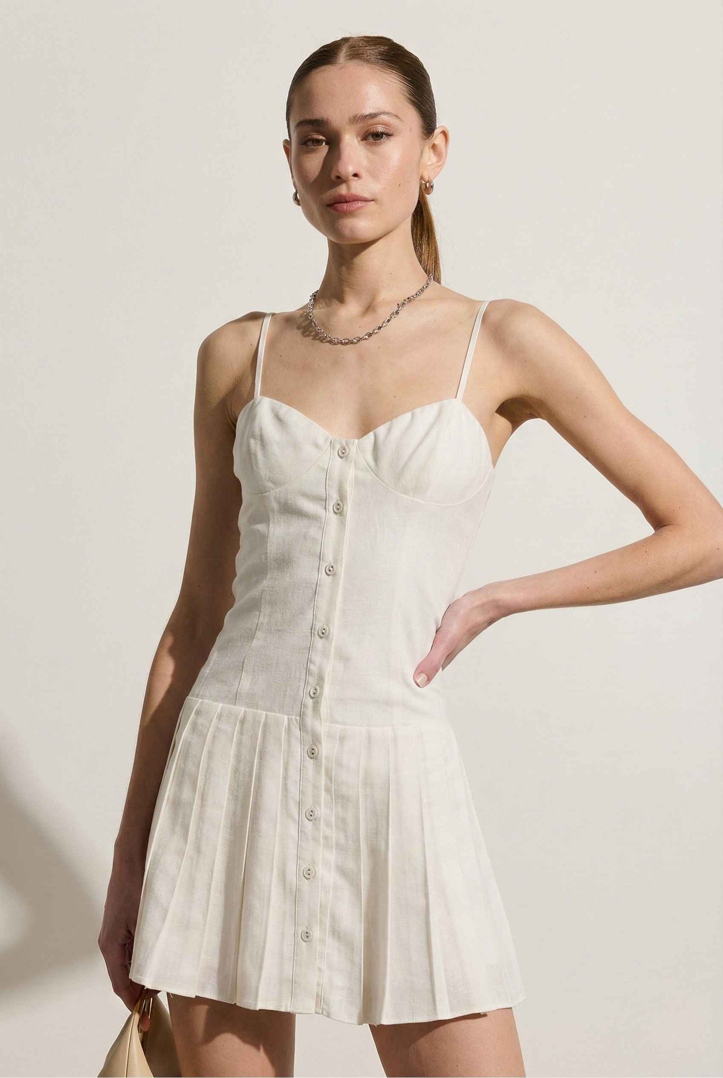 Woman wearing a Eloise Mini White Linen Blend Button Front Dress against a plain background
