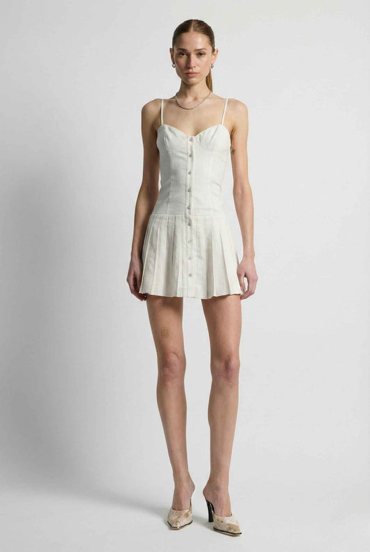 Woman wearing a Eloise Mini White Linen Blend Button Front Dress with buttons on a plain background