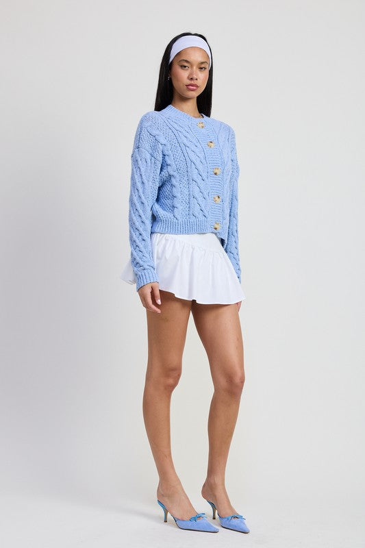 Emory Park Chunky Cable Knit Cardigan in light blue worn by model with white ruffled mini skirt and matching blue heels