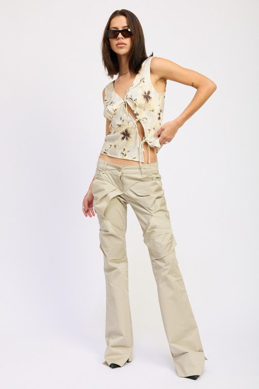 Emory Park model wearing floral tie front sleeveless top with side ties and beige low rise wide leg pants
