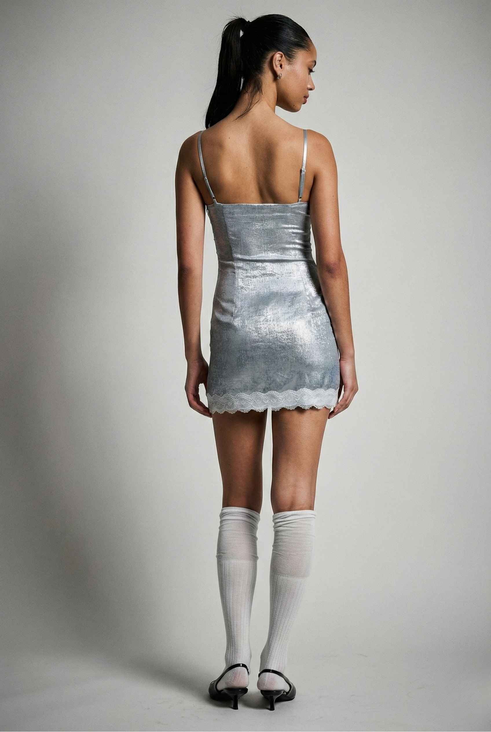 Woman wearing a Esme Mini Light Blue Satin Lace Hem Dress with a plain background