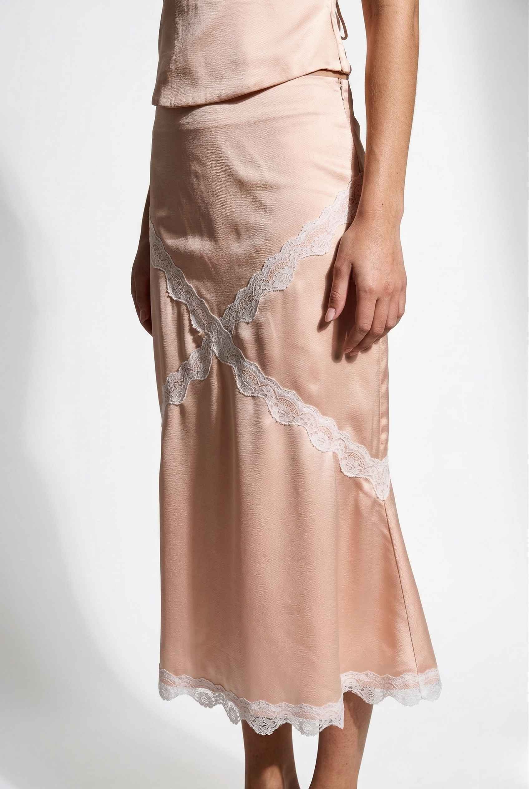 Freya Skirt | Blush Pink Satin Midi Skirt with White Lace Detail with lace trim on a white background