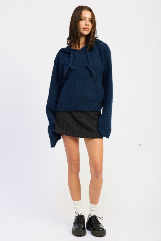 Emory Park Fringe Hoodie With Drawstrings in Navy, styled with a pleated skirt for a trendy look