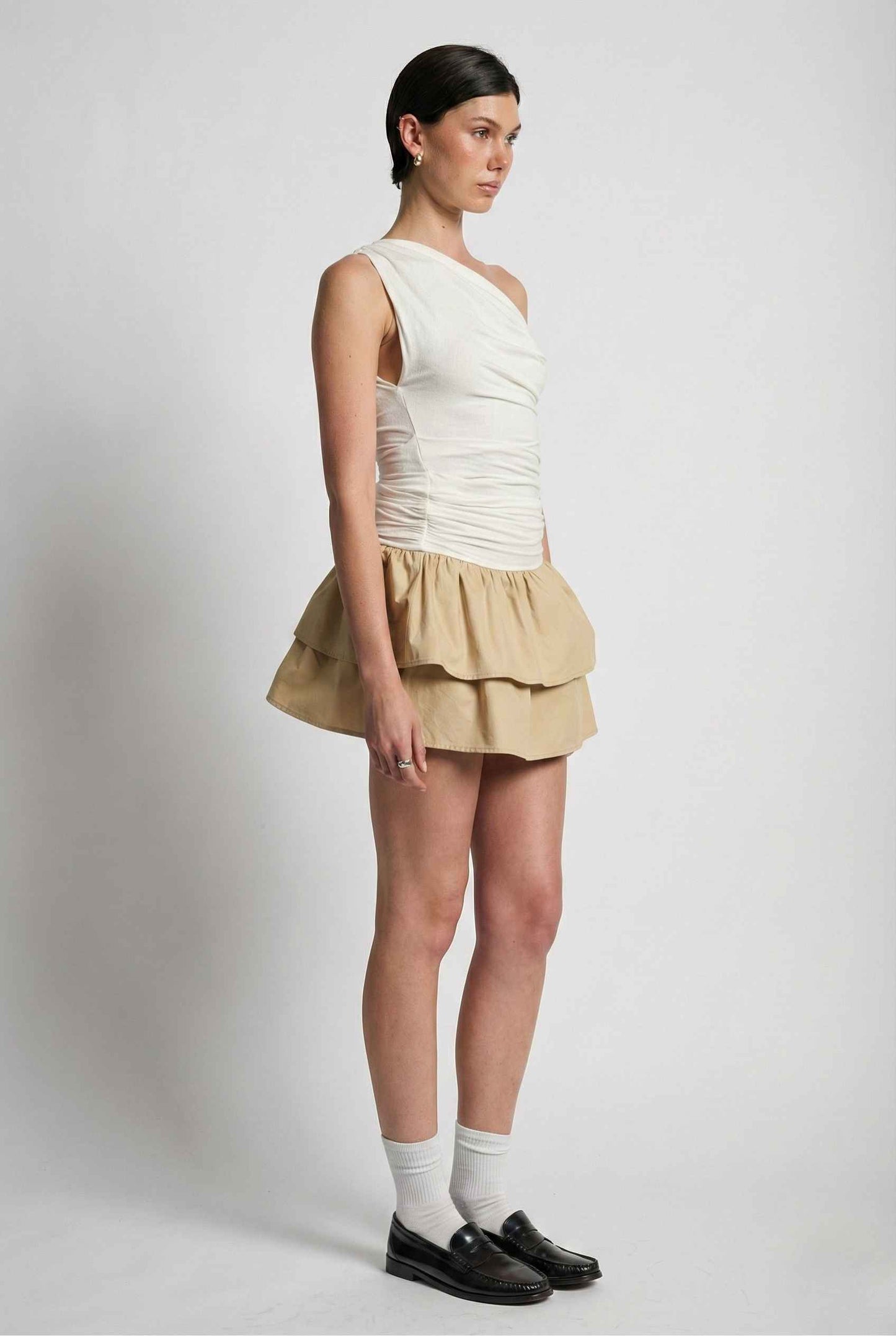 Woman wearing a Hadley Mini Ivory Ruched One-Shoulder Mixed Media Dress on a plain background