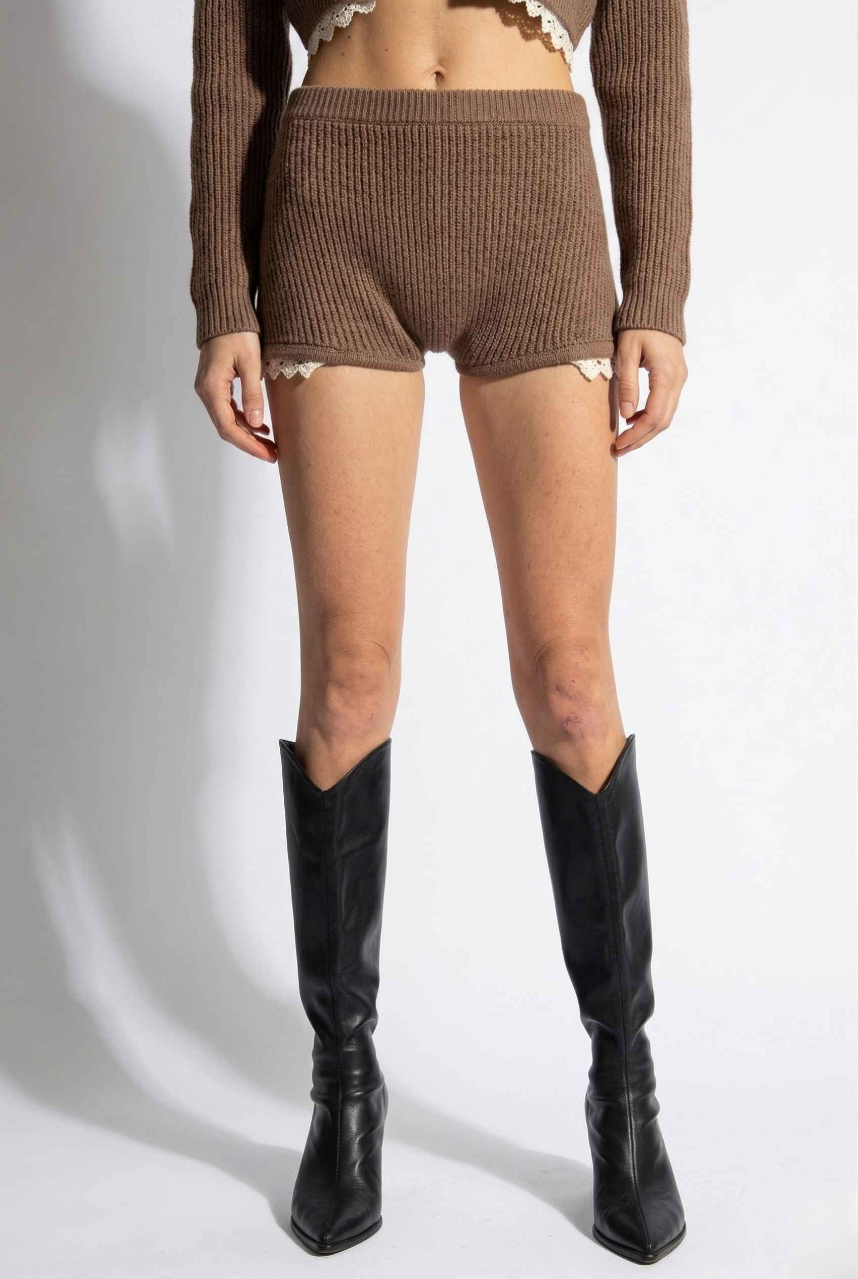 Woman wearing Hazel Shorts Brown Ribbed Knit Micro Shorts with Lace Trim and black knee-high boots on a white background