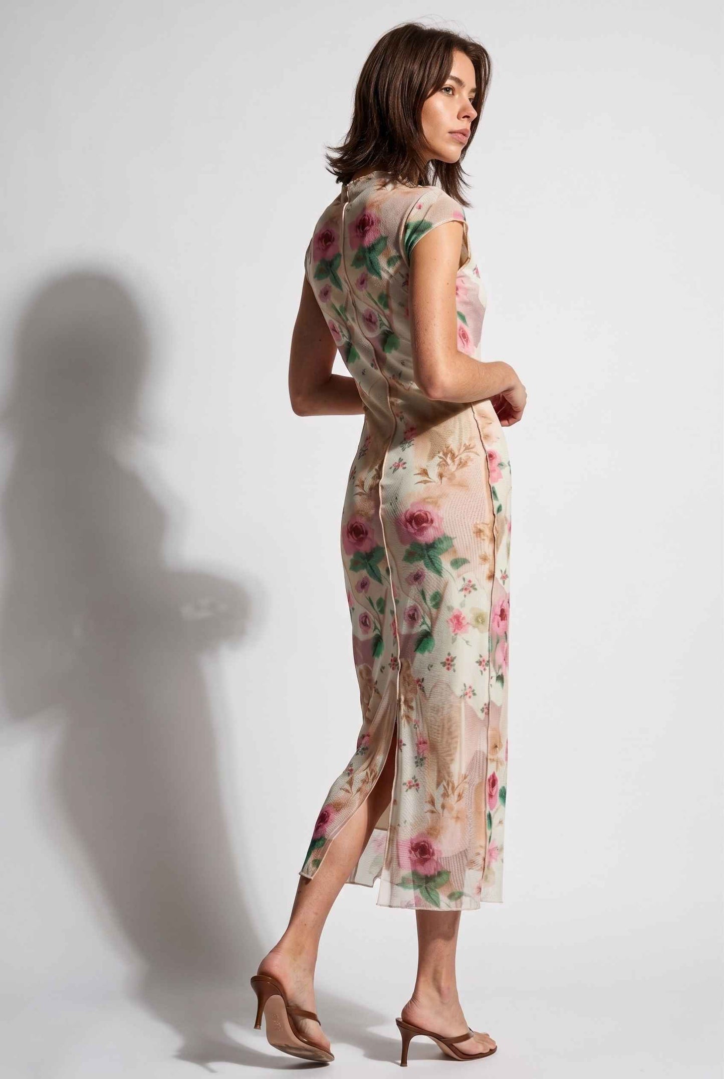 Model wearing Isabella Floral Mesh Midi Dress in Rose Floral Cap Sleeve Column Dress paired with heeled sandals back view