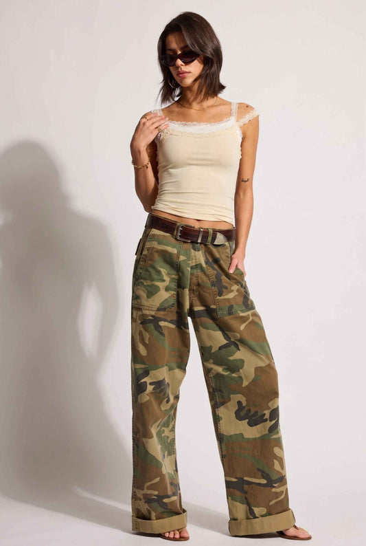 Model wearing Isabella Layered Lace Cami in Butter Yellow Lace Trim Tank Top paired with camo cargo pants and sandals