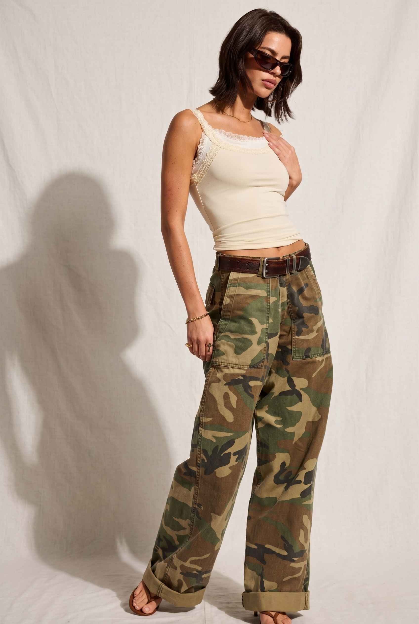 Model wearing Isabella Layered Lace Cami in Butter Yellow Lace Trim Tank Top paired with camo cargo pants and sandals