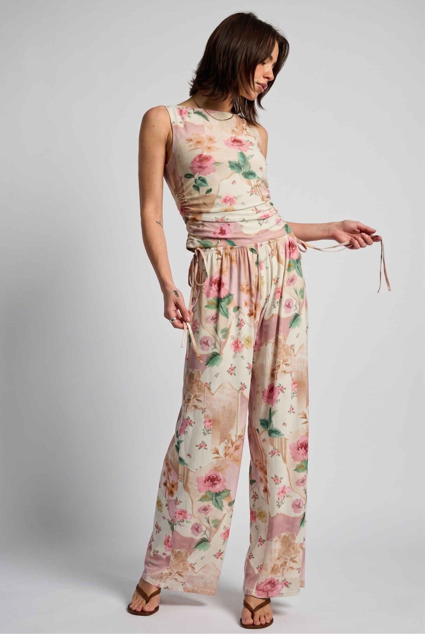 Model wearing Isabella Ruched Floral Tank in Rose Floral Sleeveless Mesh Top paired with matching bottoms and heeled sandals