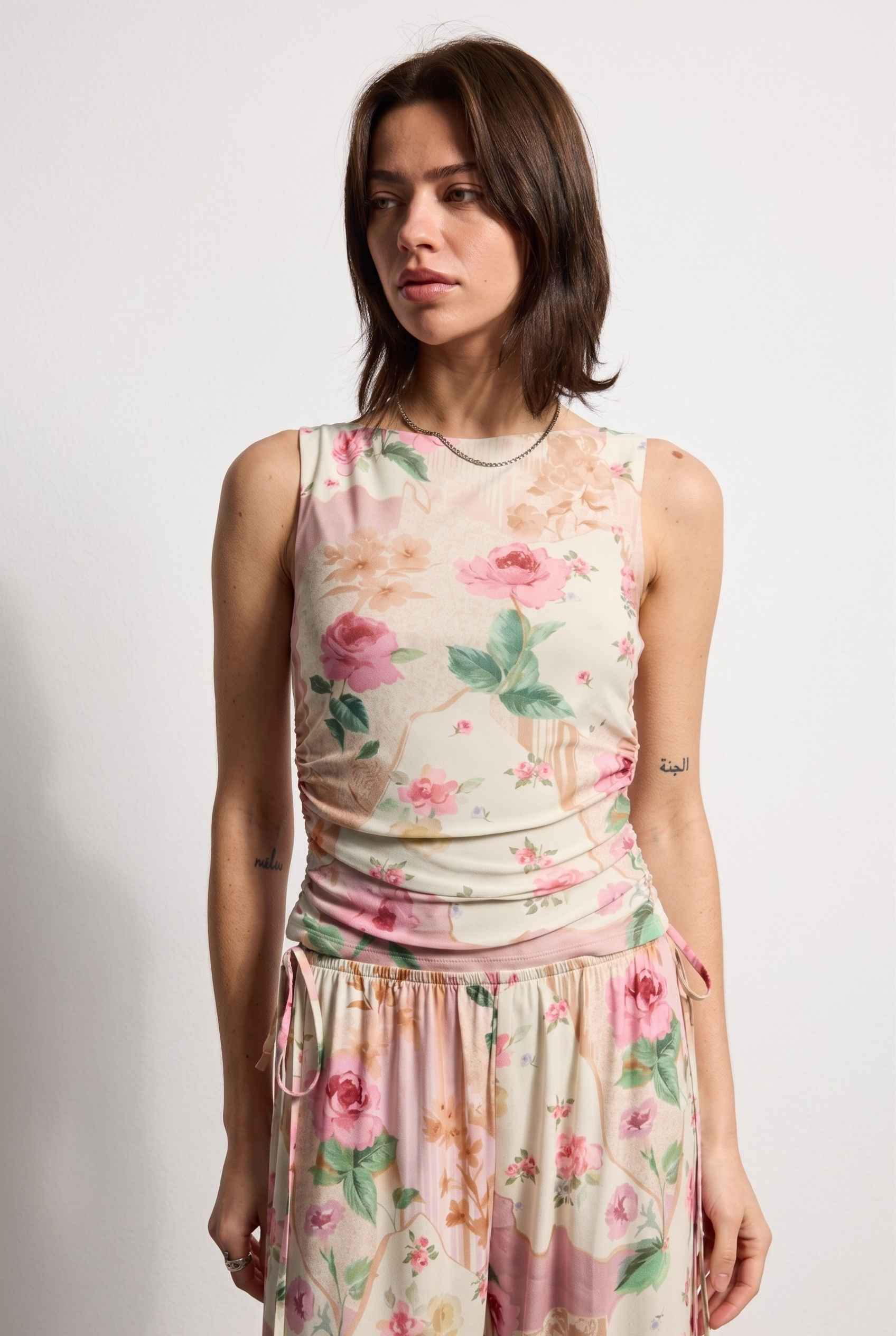 Model wearing Isabella Ruched Floral Tank in Rose Floral Sleeveless Mesh Top paired with matching bottoms close up vintage floral pattern