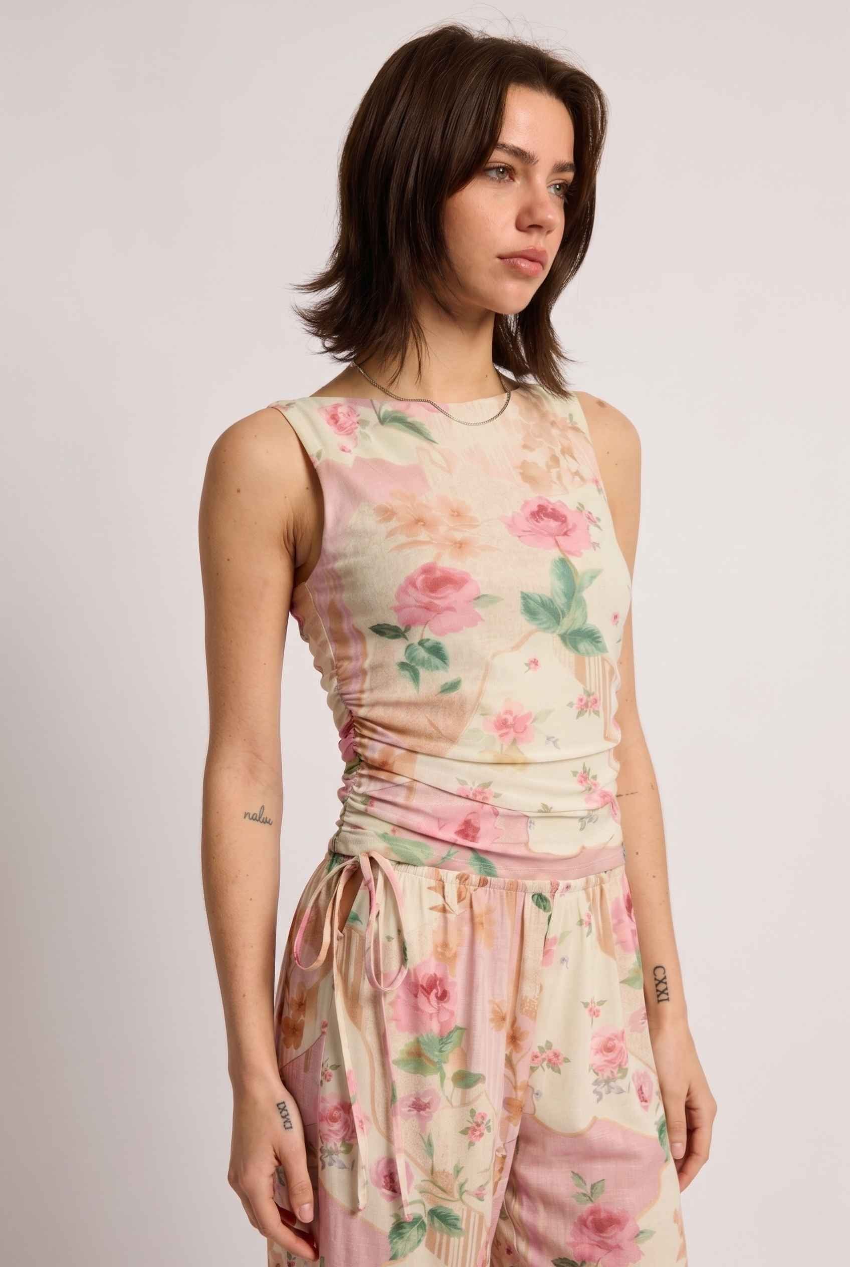Model wearing Isabella Ruched Floral Tank in Rose Floral Sleeveless Mesh Top paired with matching bottoms close up vintage floral pattern