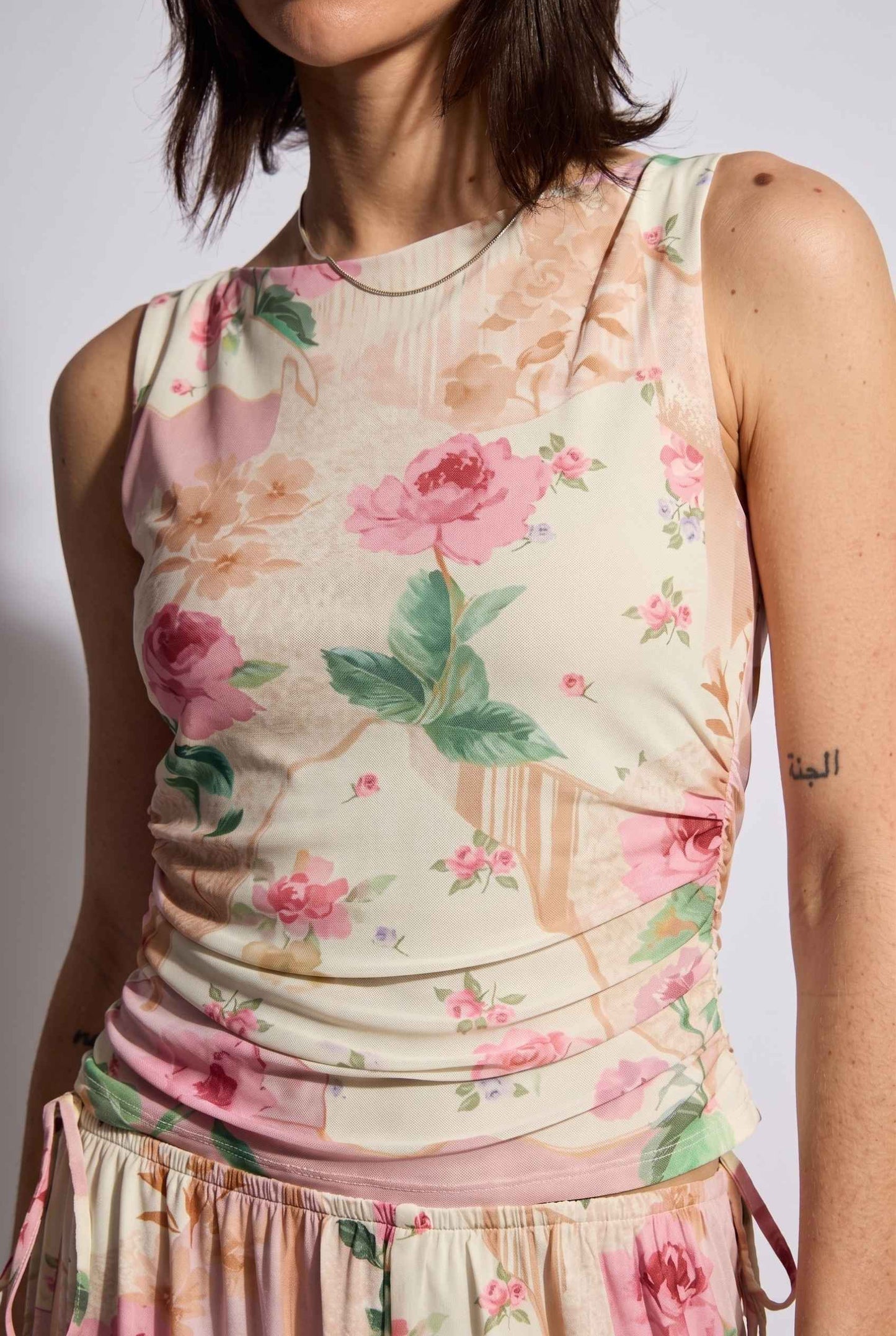 Model wearing Isabella Ruched Floral Tank in Rose Floral Sleeveless Mesh Top paired with matching bottoms close up soft light fabric