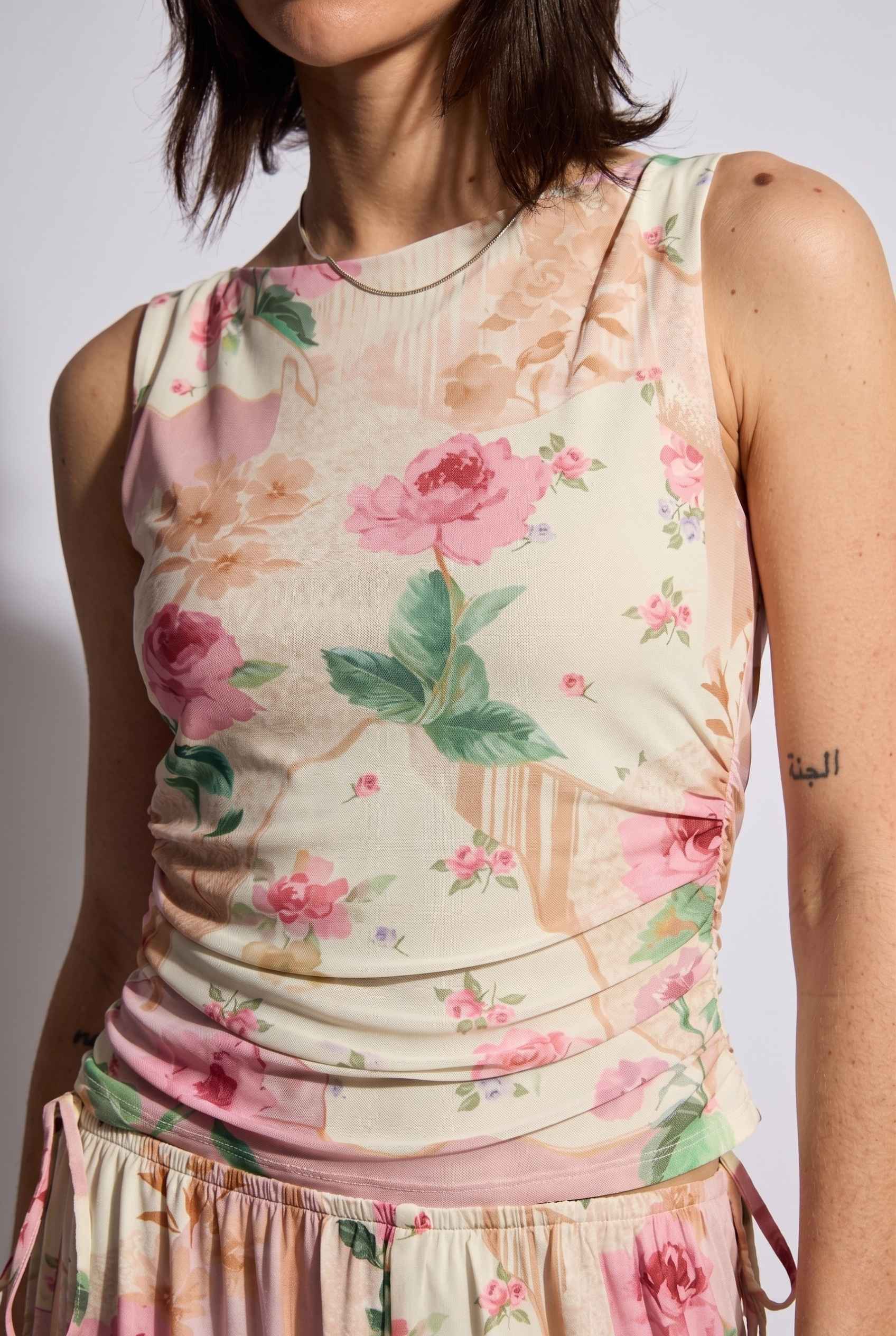 Model wearing Isabella Ruched Floral Tank in Rose Floral Sleeveless Mesh Top paired with matching bottoms close up soft light fabric