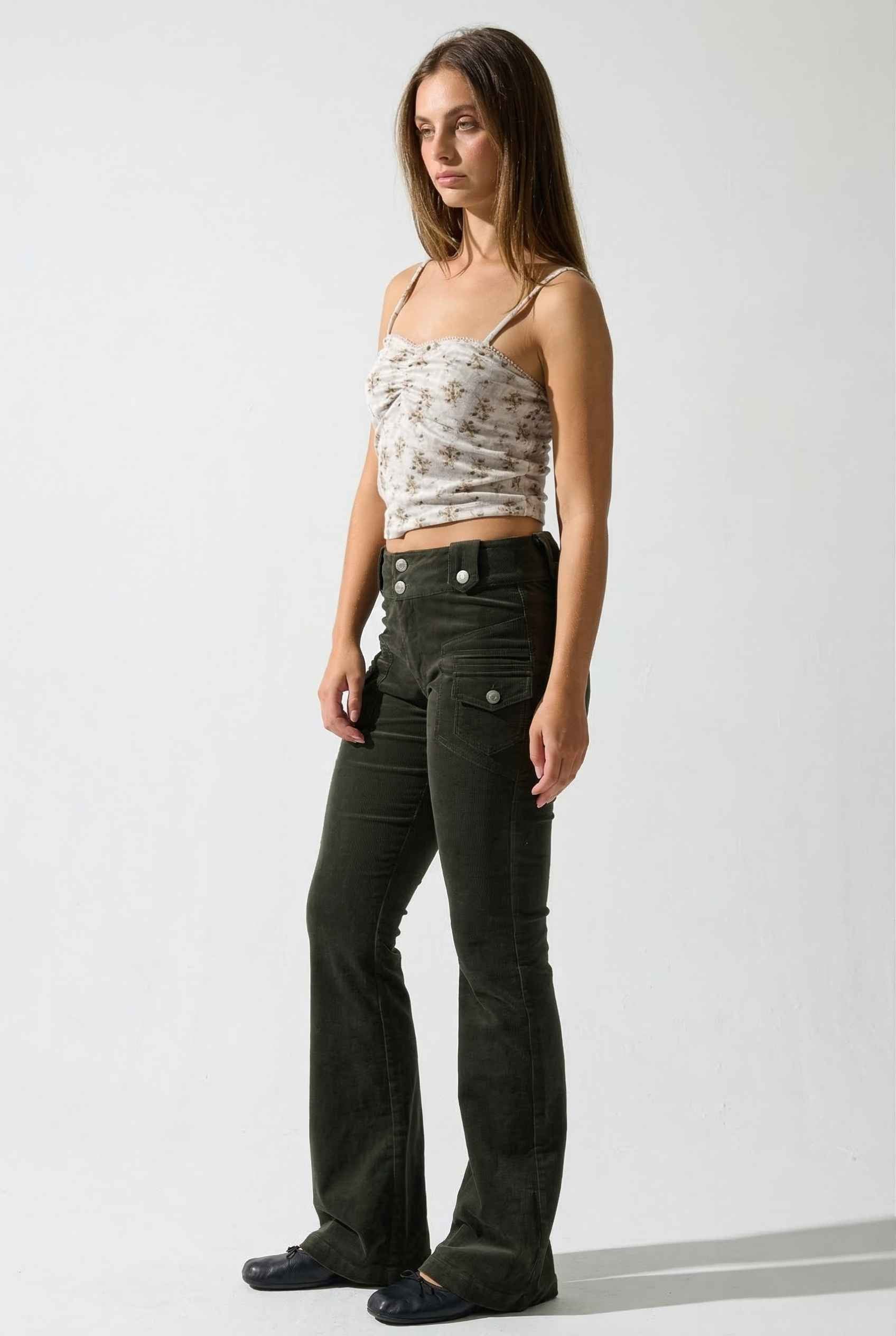 Woman wearing a Ivy Top Ivory Floral Crushed Velvet Lace Trim Cami and dark pants on a white background