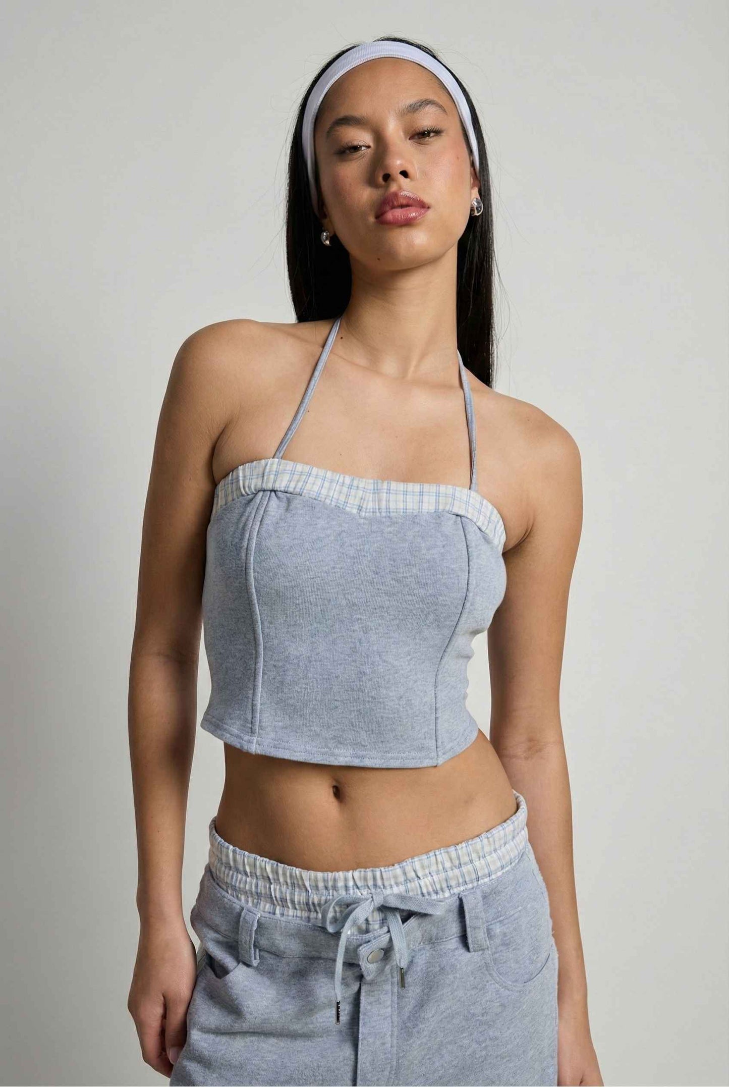 Model wearing Jamie Pants in Blue Double-Waist Boxer Style Trousers with matching halter top and sneakers against plain backdrop